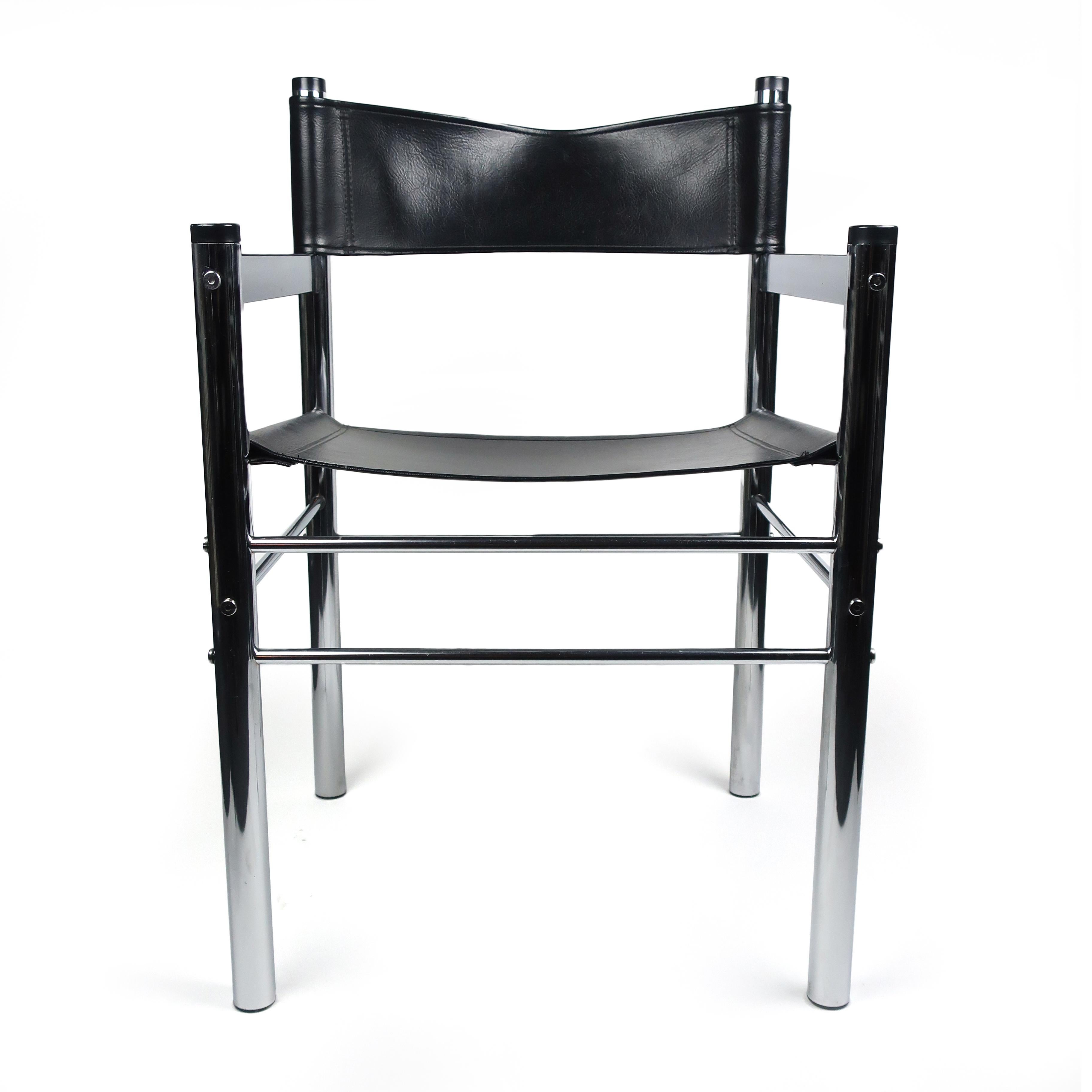A Minimalist mod chrome and black vinyl armchair designed with four tubular chrome legs and arm rests and a black vinyl sling seat and back.

In excellent vintage condition with wear consistent with age and use.

Measures: 18