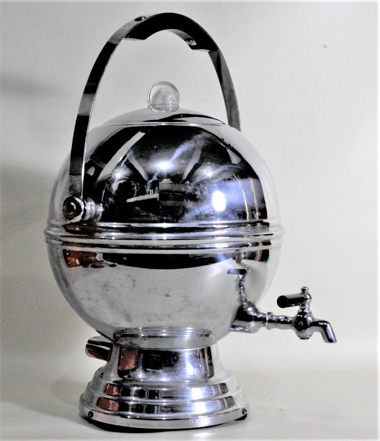 This Mid-Century Modern electric coffee percolator was made by the Labelle's Silver Company of the United States in circa 1960 in the machine age style. This ball shaped percolator is done in chrome with black accents to the handle and spigot and