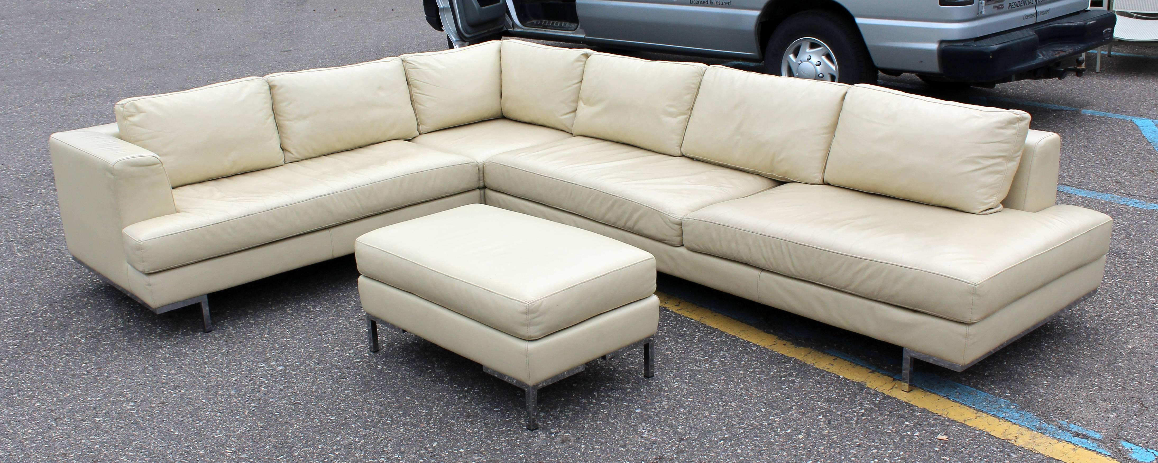 For your consideration is a gorgeous, three piece leather sectional sofa on chrome feet with matching ottoman, possibly B&B Italia. In very good condition. The dimensions of each piece are 92