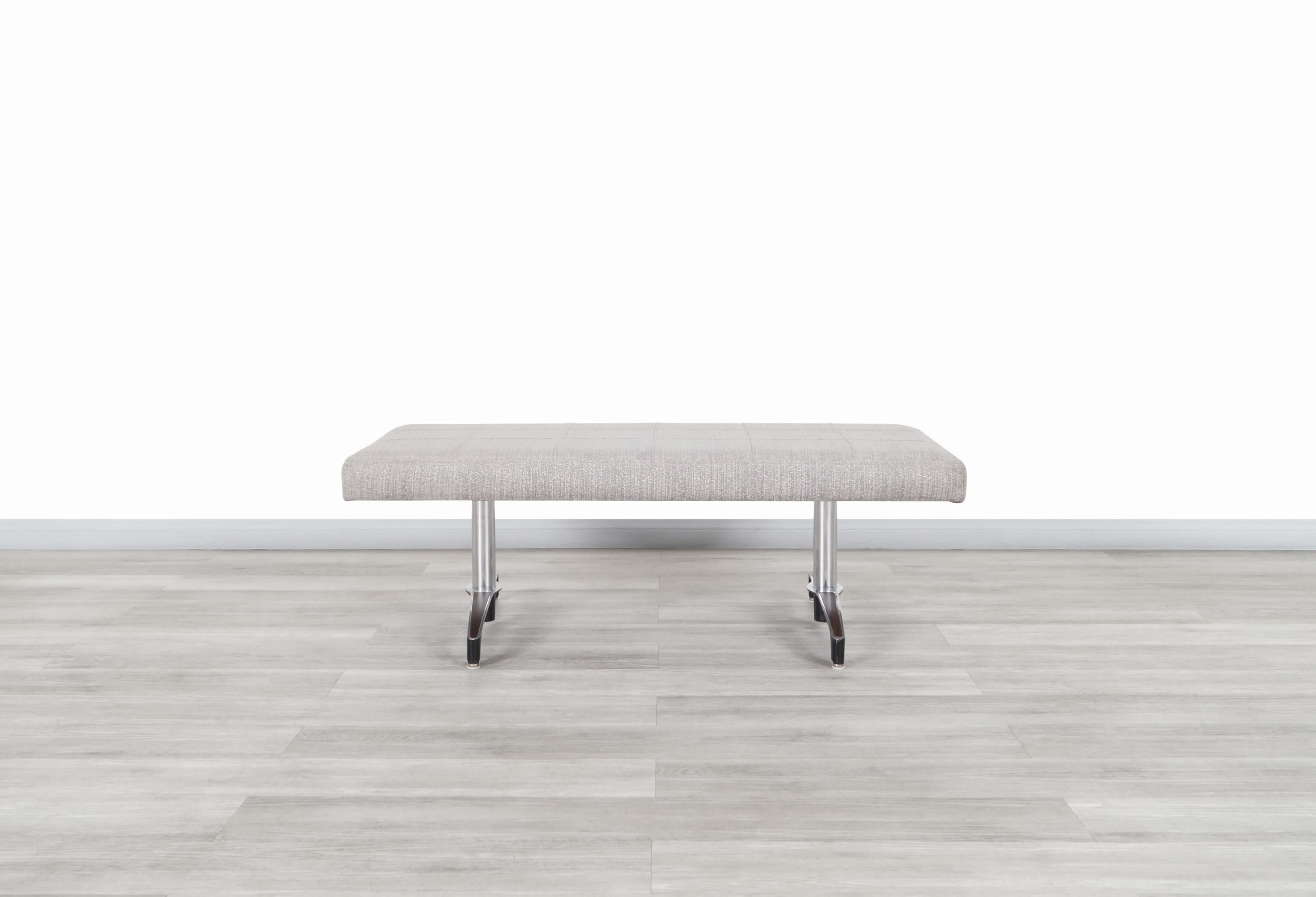 Fabulous Mid-Century Modern chrome bench designed and manufactured in the United States, circa 1970s. Features a wide and comfortable seat that has been newly reupholstered in beautiful gray fabric, which gives it an elegant touch causing it to