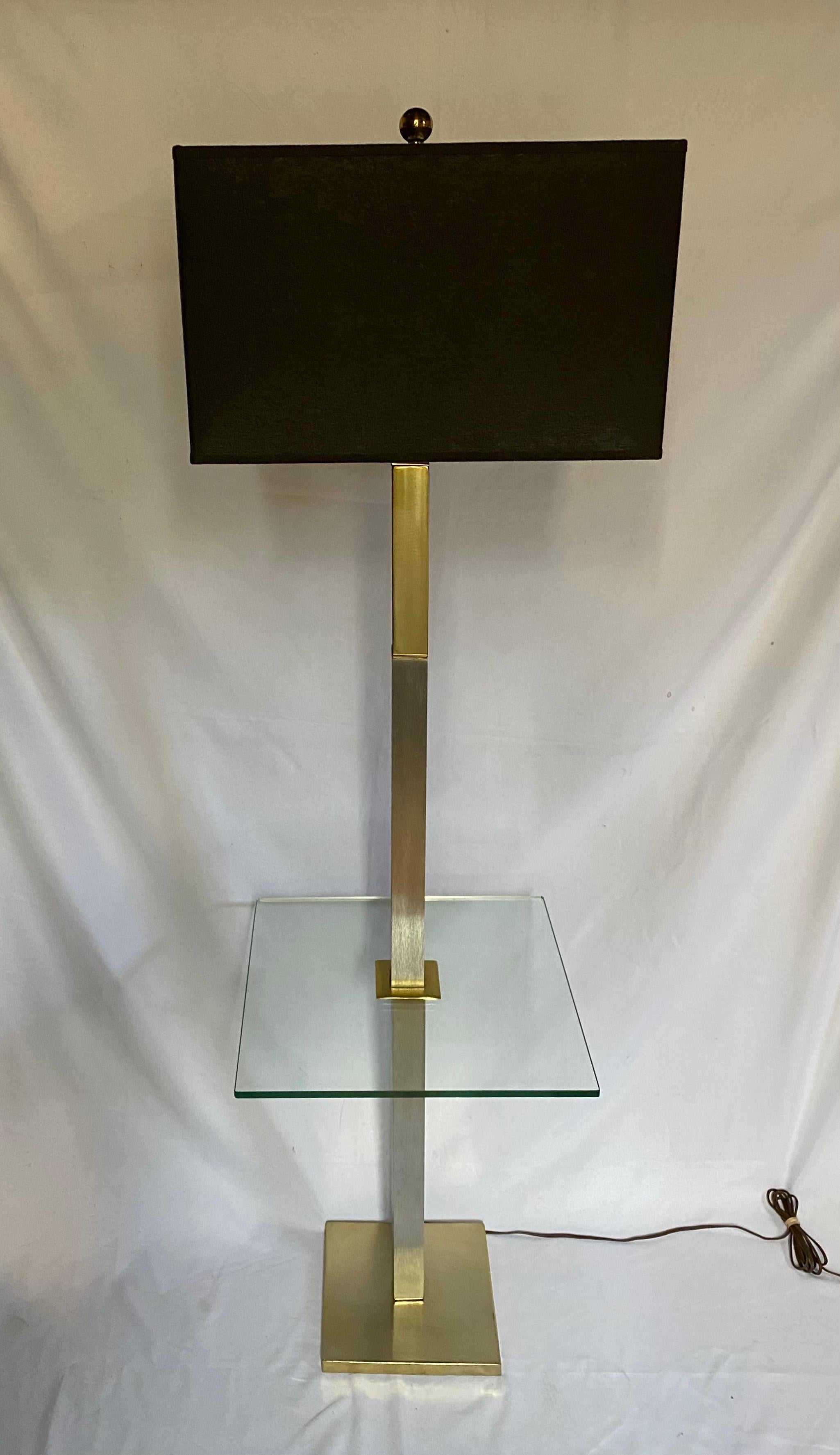 Mid-Century Modern mixed metal floor lamp with glass tabletop. This side table lamp features polished brass and brushed chrome metal accents with a clear glass square tabletop.  Lamp shade not included. 