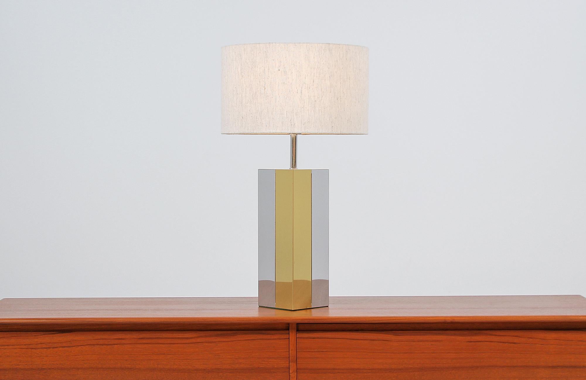 Dazzling modern table lamp designed and manufactured in the United States, circa 1960s. This unique and elegant lamp features a tall chrome and brass plated rectangular body in vertical panels on this Minimalist and geometric design. The plated