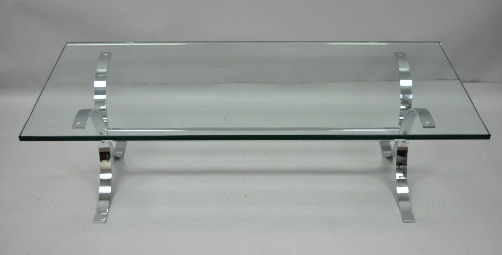 Vintage chrome butterfly base glass top coffee table in the Milo Baughman style. Item features 1.75