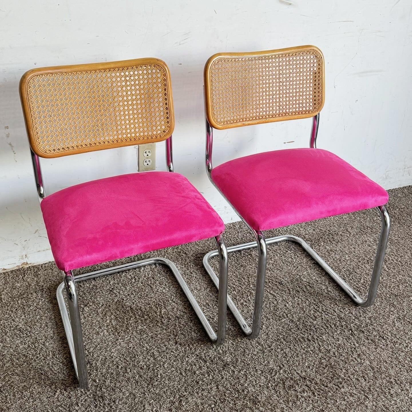 Add a pop of color and style to your dining space with this pair of Mid Century Modern Cantilever Chairs. Featuring sleek chrome frames, classic cane backs, and vibrant pink upholstered seats, these chairs blend retro charm with contemporary design.