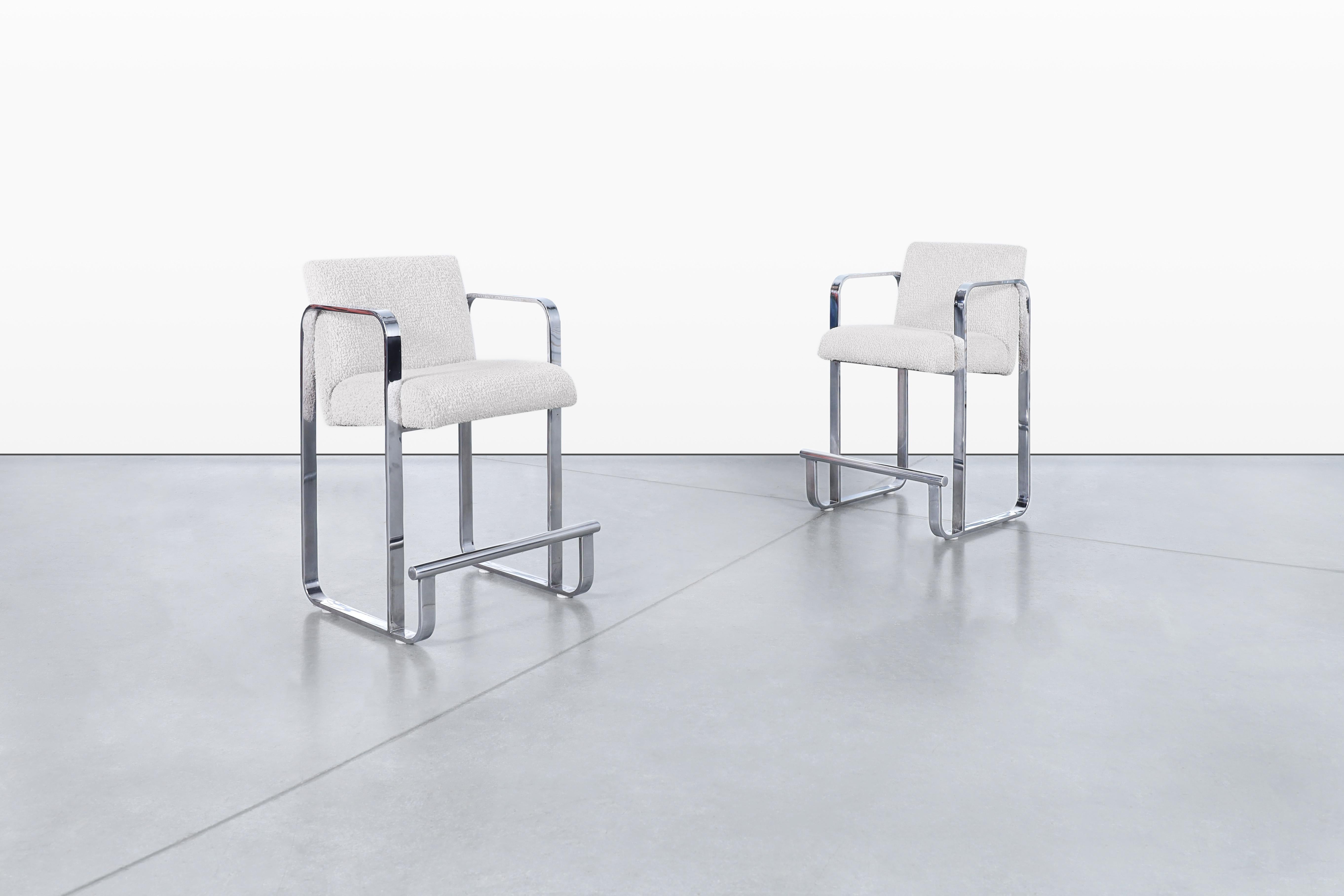 A stunning pair of vintage chrome counter stools that beautifully encapsulate the style of the 1970s. Crafted in the United States, these stools feature a sleek and streamlined design that adds a touch of retro elegance to any space. With a thick