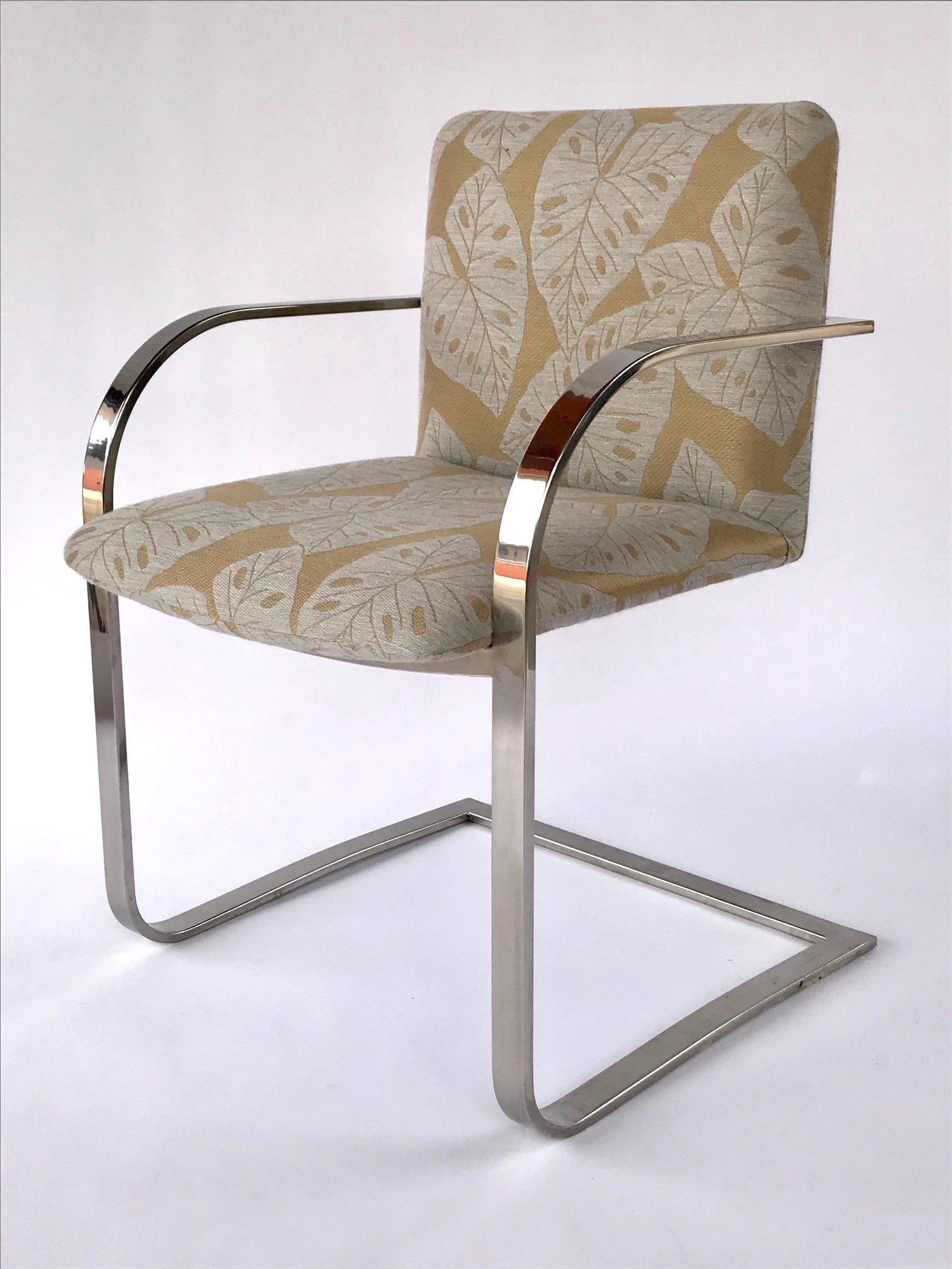 Mid-Century Modern desk chair or side chair with cantilevered steel frame in chrome. Chair has streamlined profile with curved armrests and floating seat design. Newly upholstered in bold handwoven fabric with tropical leaf print in monochromatic