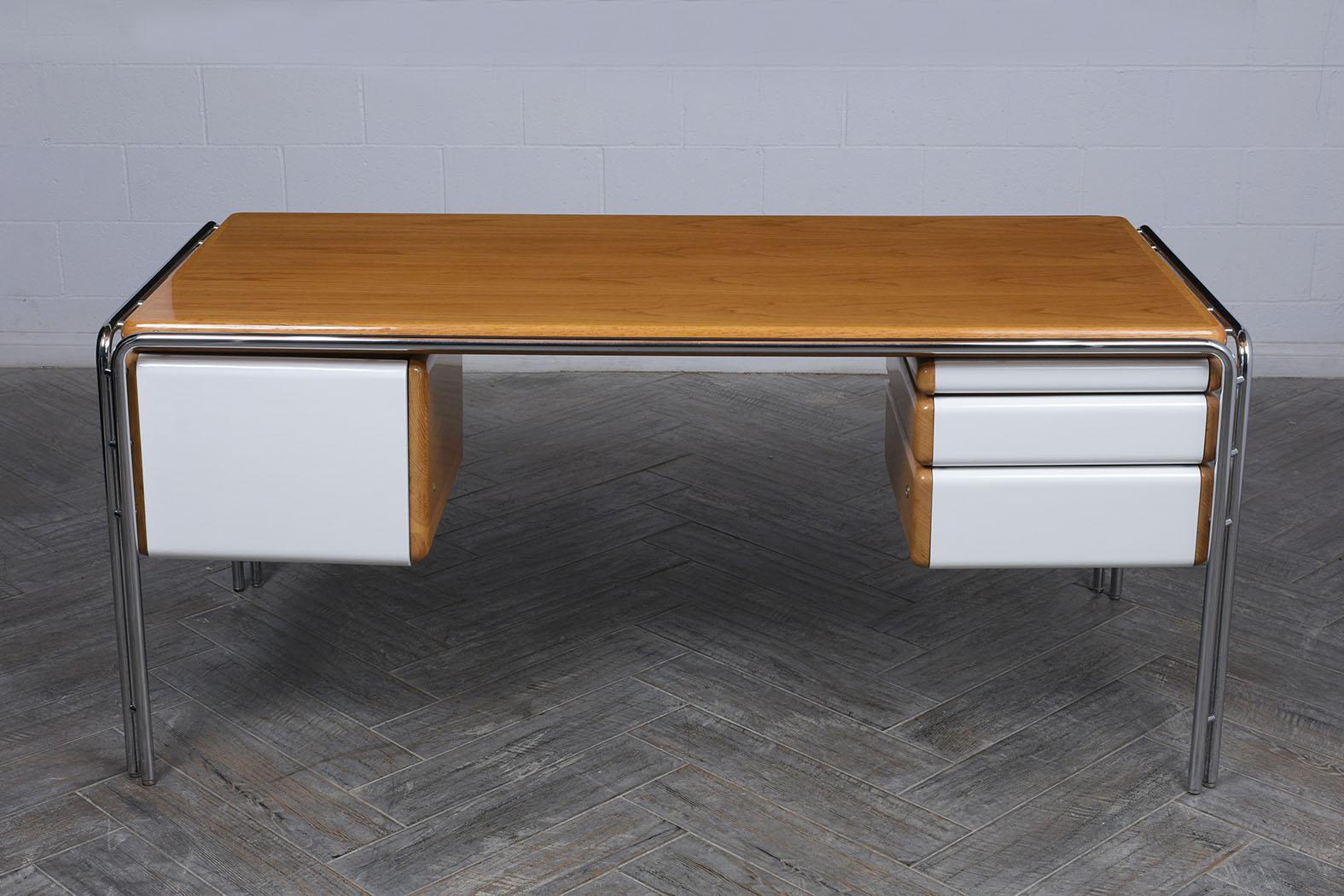 This 1960's Modern Floating Desk has been fully restored and stained in light oak & white color combination with a newly lacquered finish. This Danish writing table features a sturdy tubular chrome frame, three small drawers that open with ease, and
