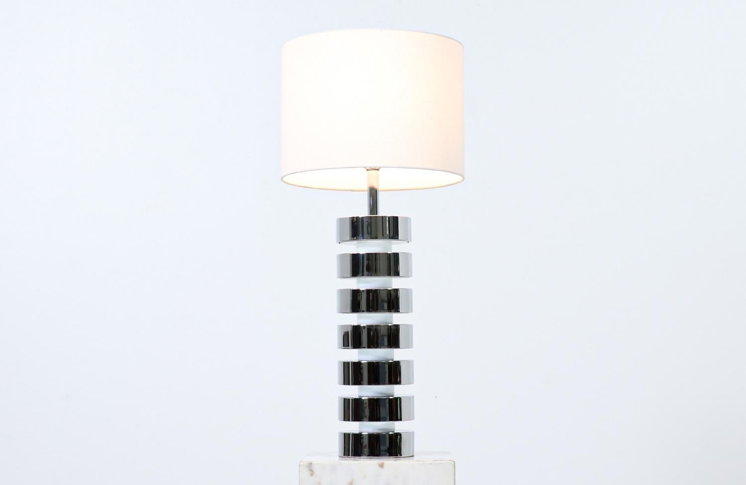 Mid-Century Modern chrome disc column table lamp.

Dimensions
33.50 in H x 6 in W x 6 in D
Shade
11 in H x 15 in W x 15 in D

