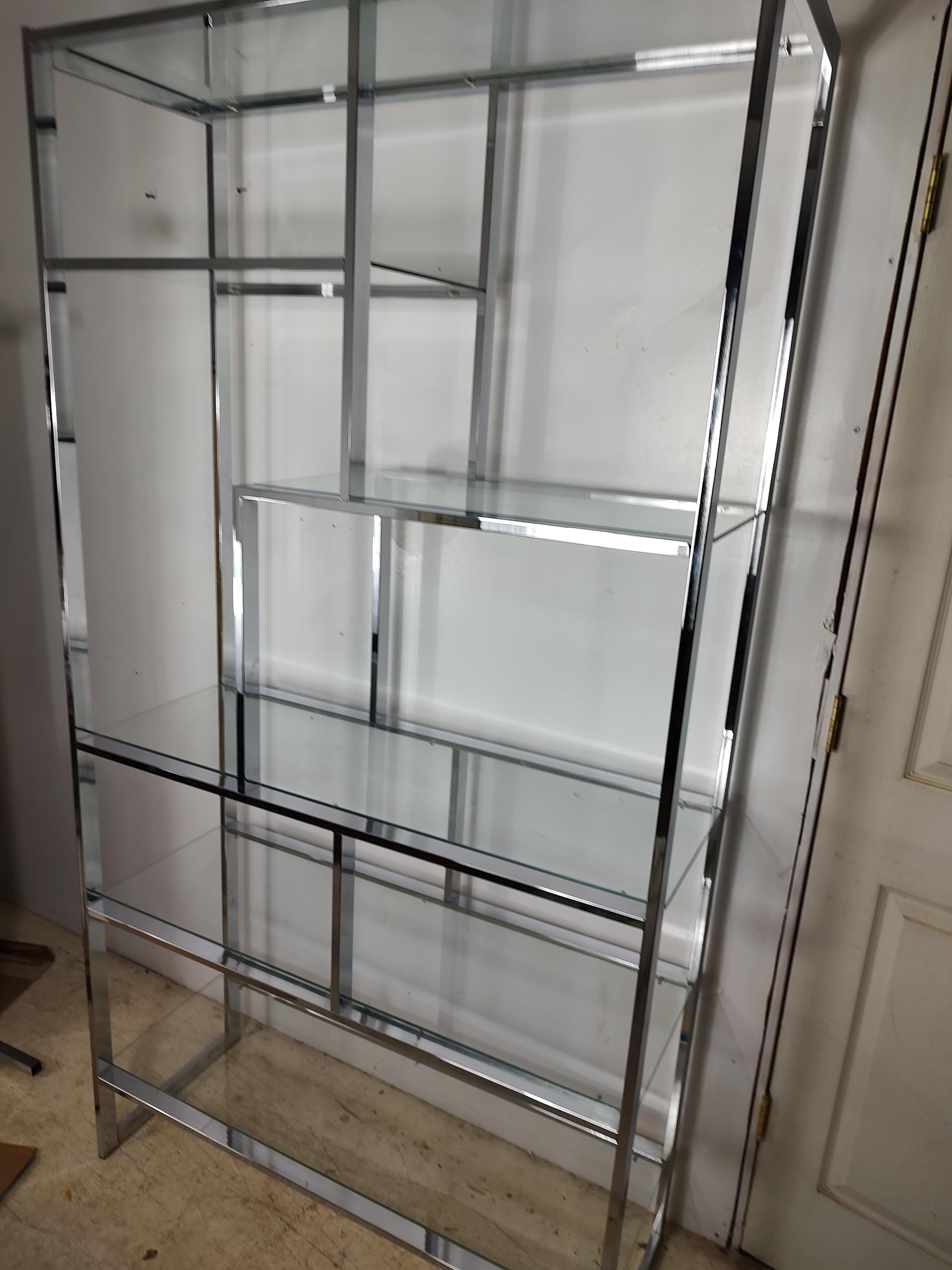 Simple and elegant chrome etagere with minimal lines. S is x shelves with plate glass to house your wares. In excellent vintage condition with minimal wear.