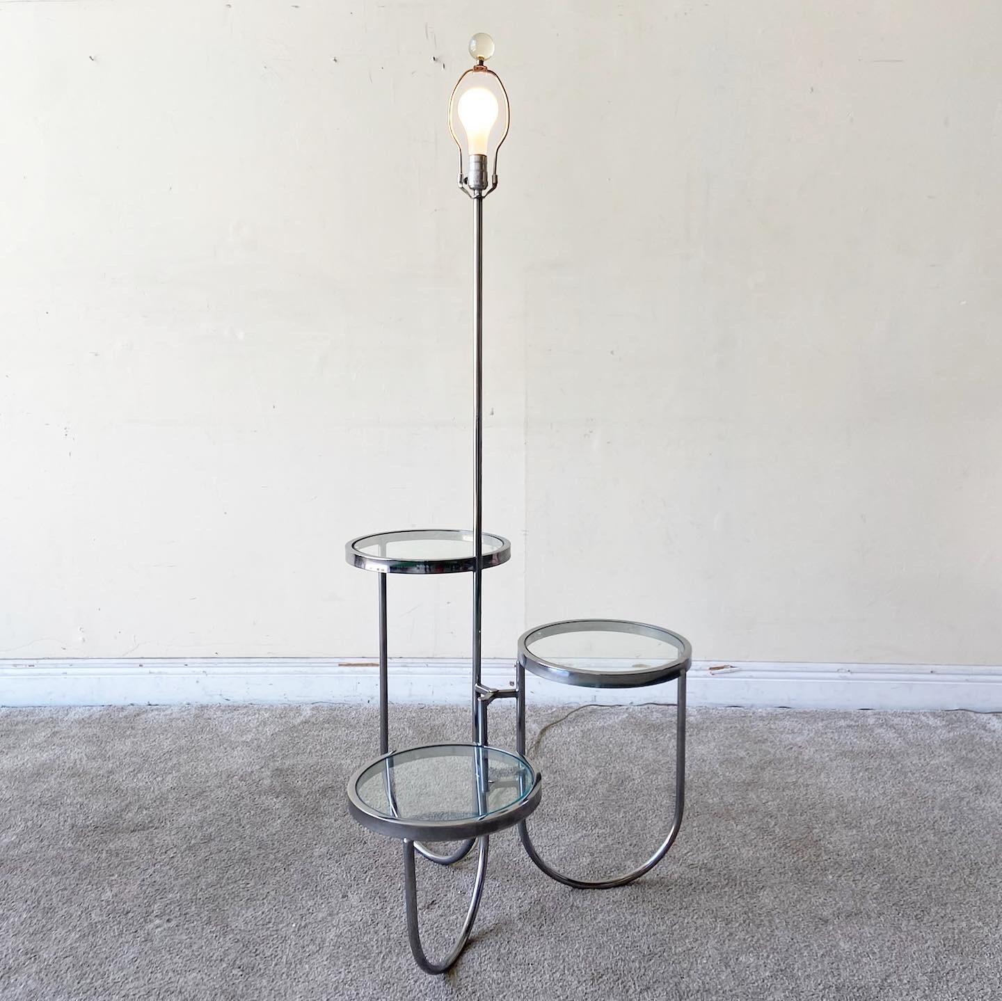 Exceptional chrome Mid-Century Modern floor lamp. Base of floor lamp is comprised of 3 circular tables ascending in circumscription of the lamp pole.

3 way lighting

Each table measures 12” D
Heights are 12”, 18”, 24.5” respectively.