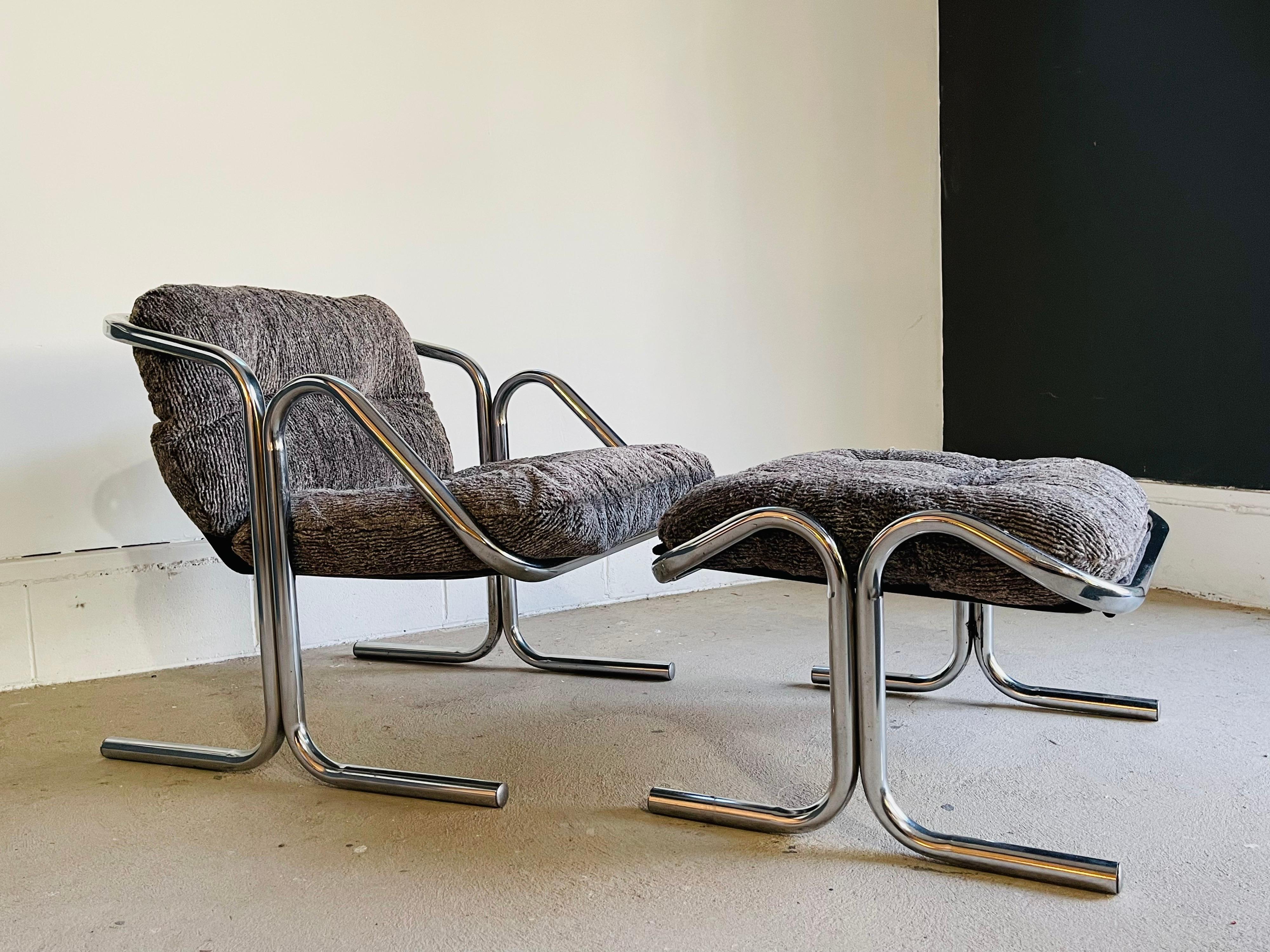 Mid-Century Modern chrome lounge chair & ottoman by Jerry Johnson for Landes. The chair has a very fluffy and soft gray fabric on a chrome frame. Both chair and ottoman are in good vintage condition with normal wear consistent with age and use. We