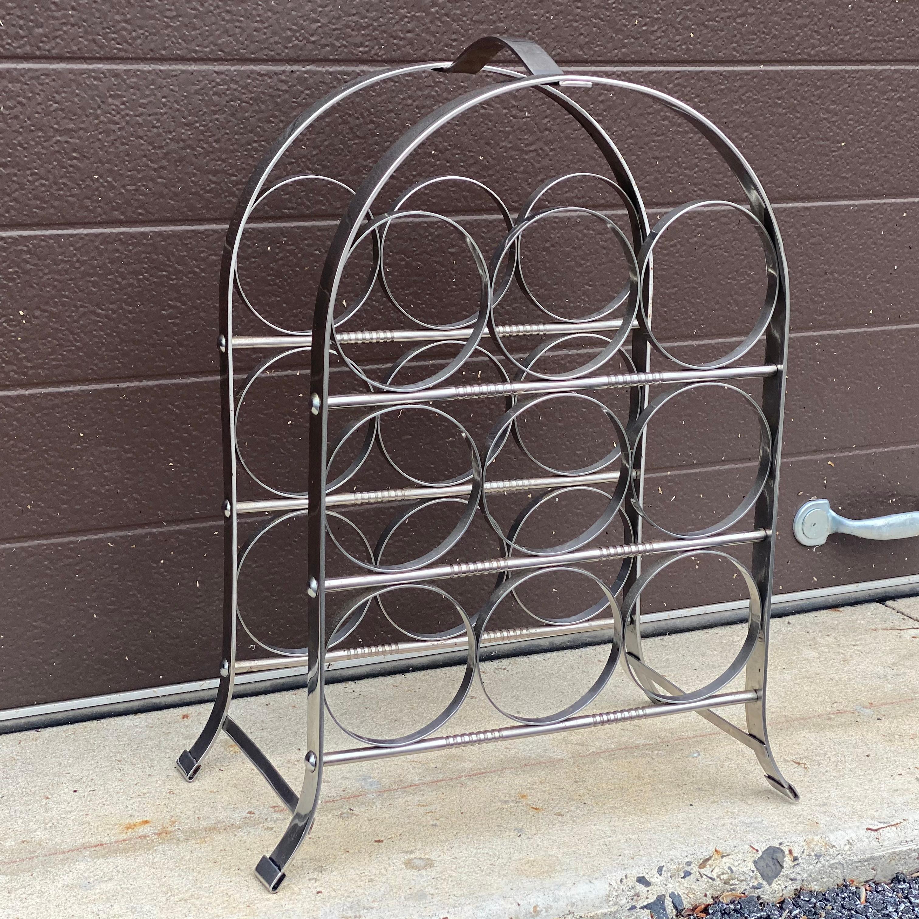 This vintage chrome tabletop wine rack circa 1960s-70s holds 9 bottles of wine and is in very good condition with heavy construction 

Measures 18.25” high, 13.75” wide and 7.25” deep.
