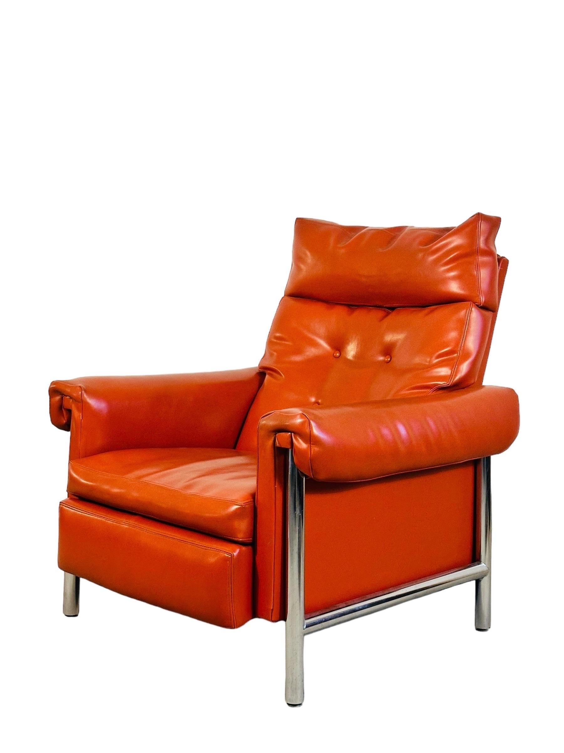 For this striking mid-century recliner lounge chair, bask in the bold, beautiful simplicity of a bygone era. This piece features a polished chrome frame that contrasts perfectly with the rich orange leather, giving it a vibrant yet sophisticated