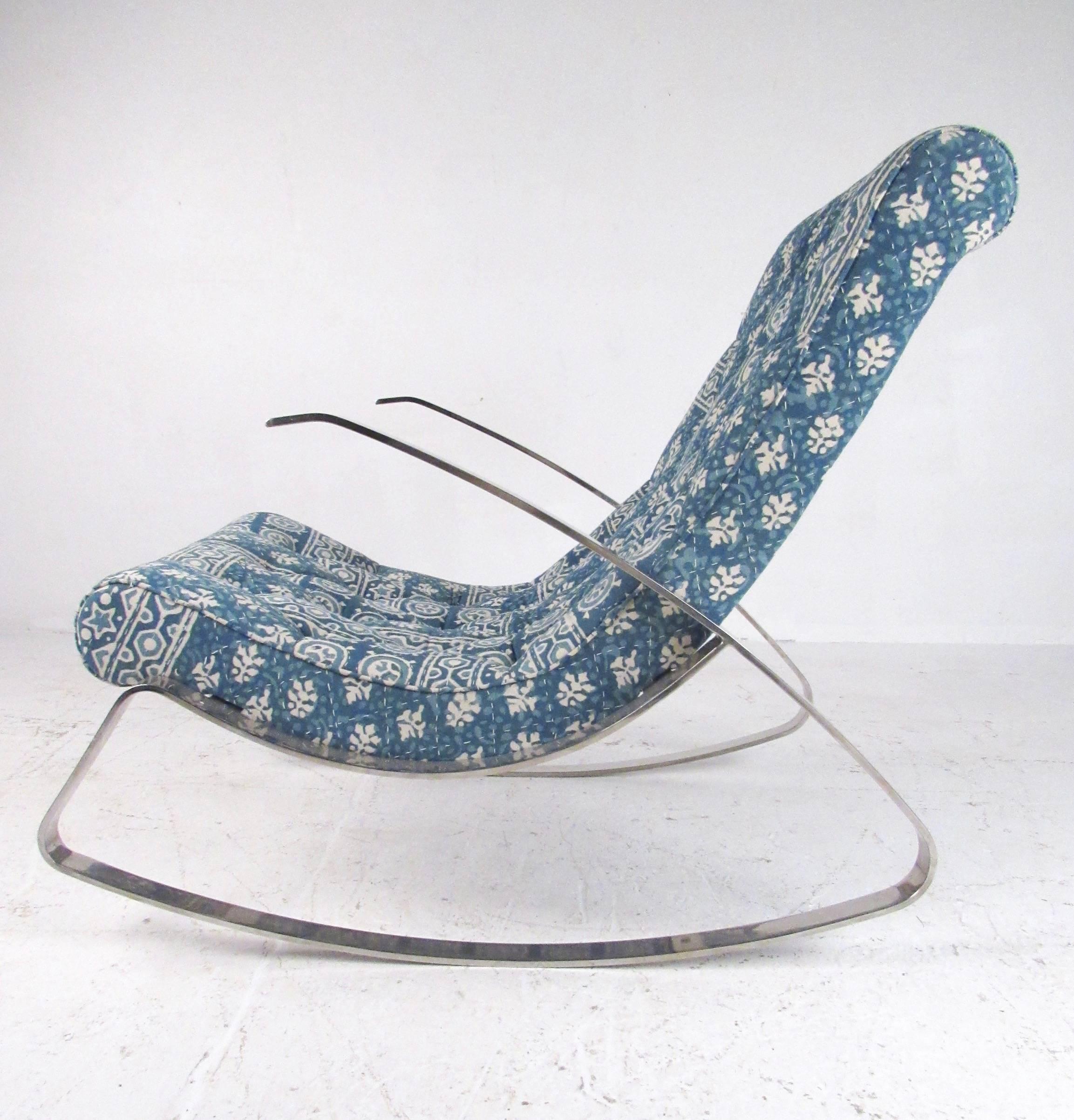 This stylish midcentury rocking chair features heavy flat chrome construction and shapely frame design. Unique patterned upholstery is tufted for added style, plush padding makes this a comfortable vintage modern chair for seating in any setting.