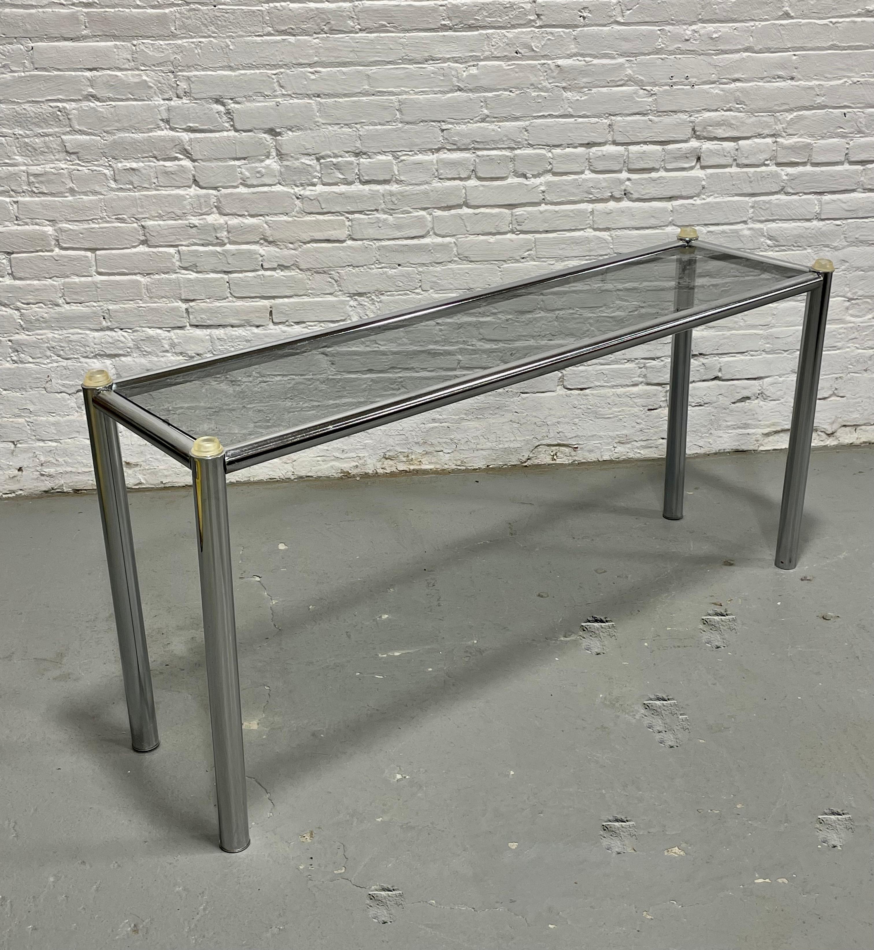 Mid Century Modern Chrome & Smoked Glass Console Table, c. 1960's. This simple and sleek table is perfect for placing behind a sofa or in a hallway or entryway with your favorite vase, lamp or other décor on top. In lovely condition with some wear