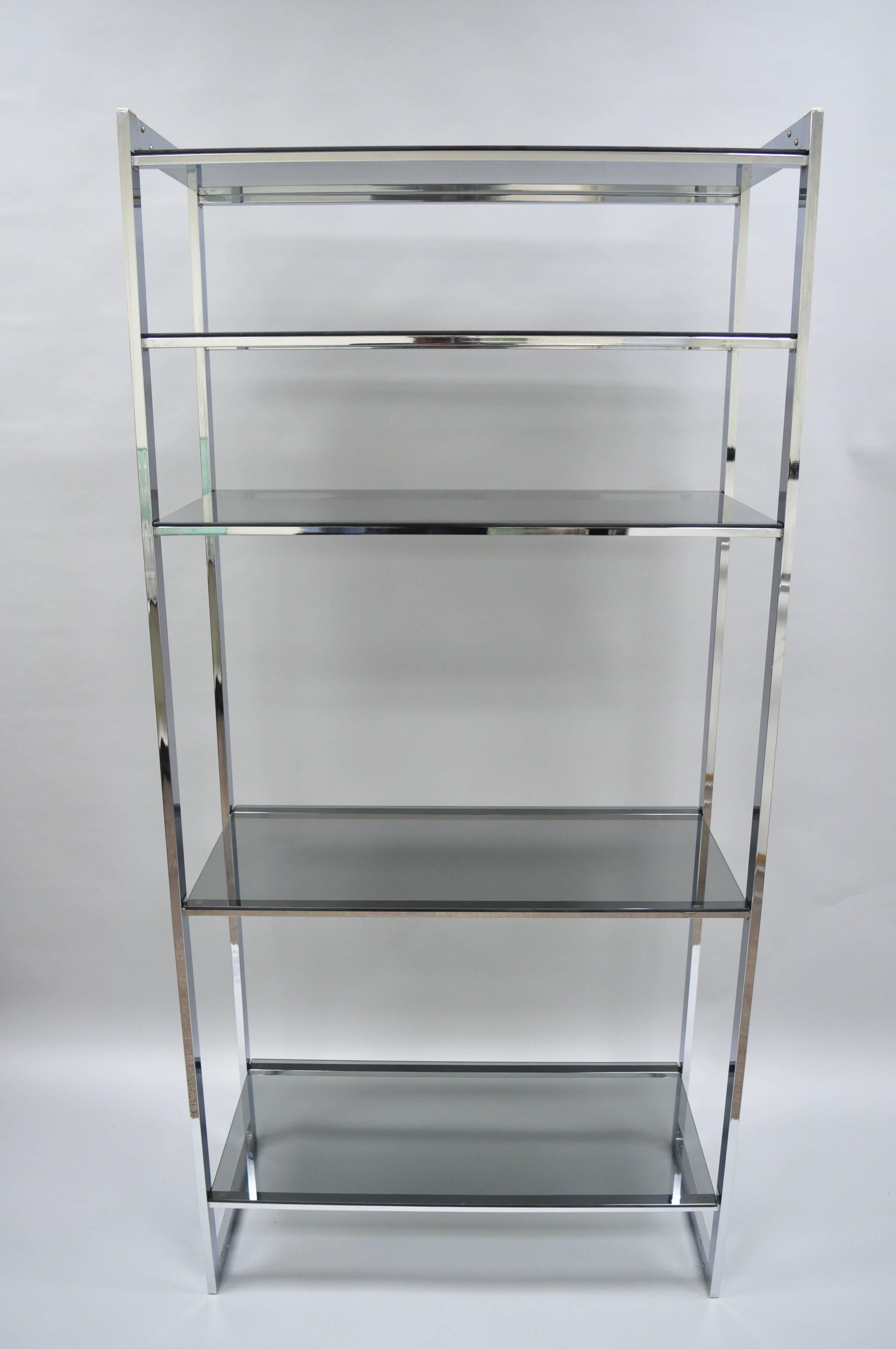 Vintage Mid-Century Modern chrome and smoked glass étagère bookcase shelf. Item features sleek chrome metal frame, five smoked glass shelves, clean modernist lines, circa 1970s. Measurements: Overall: 74