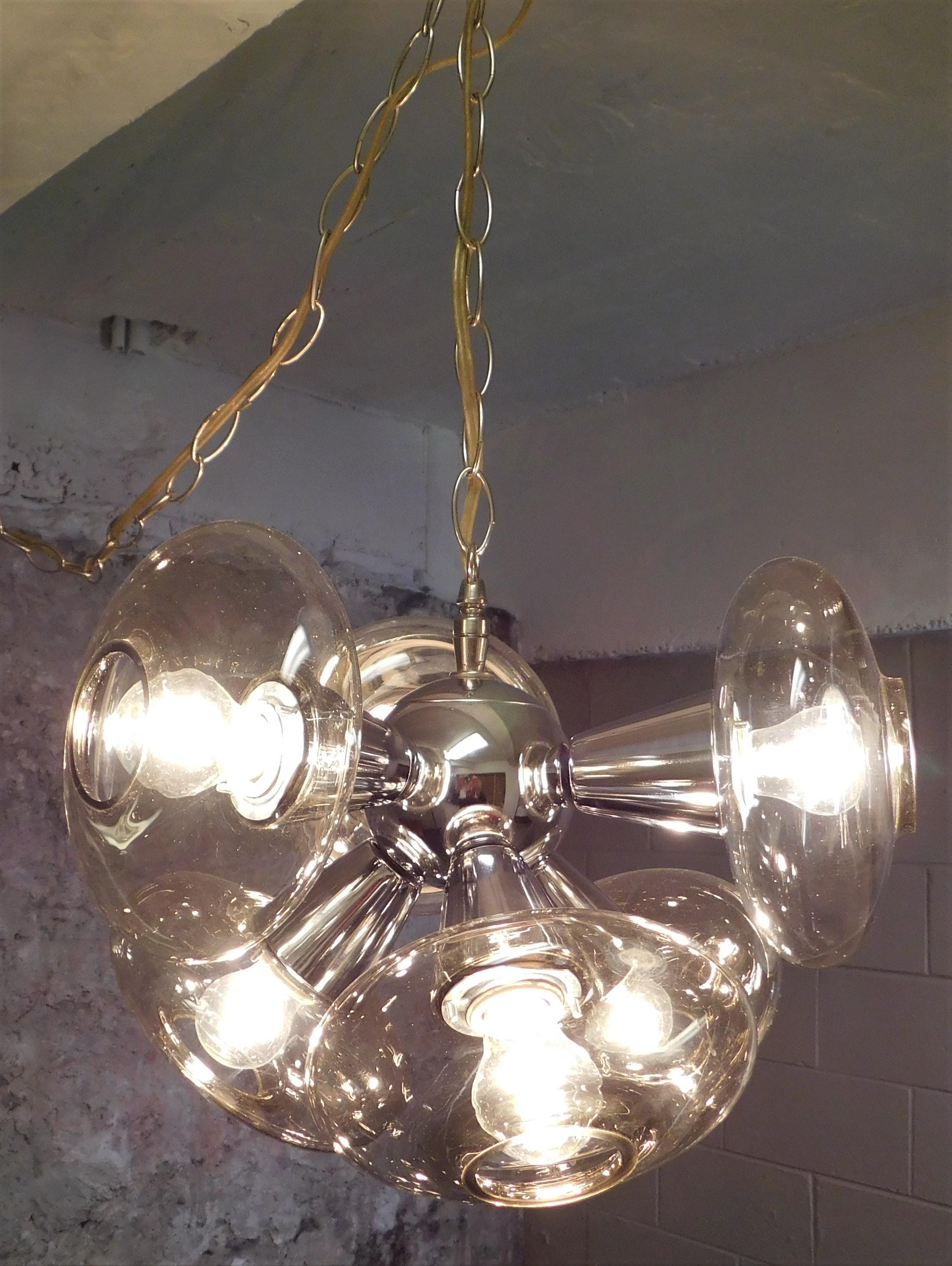 Excellent condition chrome hanging Sputnik light with six lights with tinted glass globes. Over 24 feet of hanging chain and electrical cord with an off on dial switch, actual fixture size is 10.5 inches high by 15 inches round.