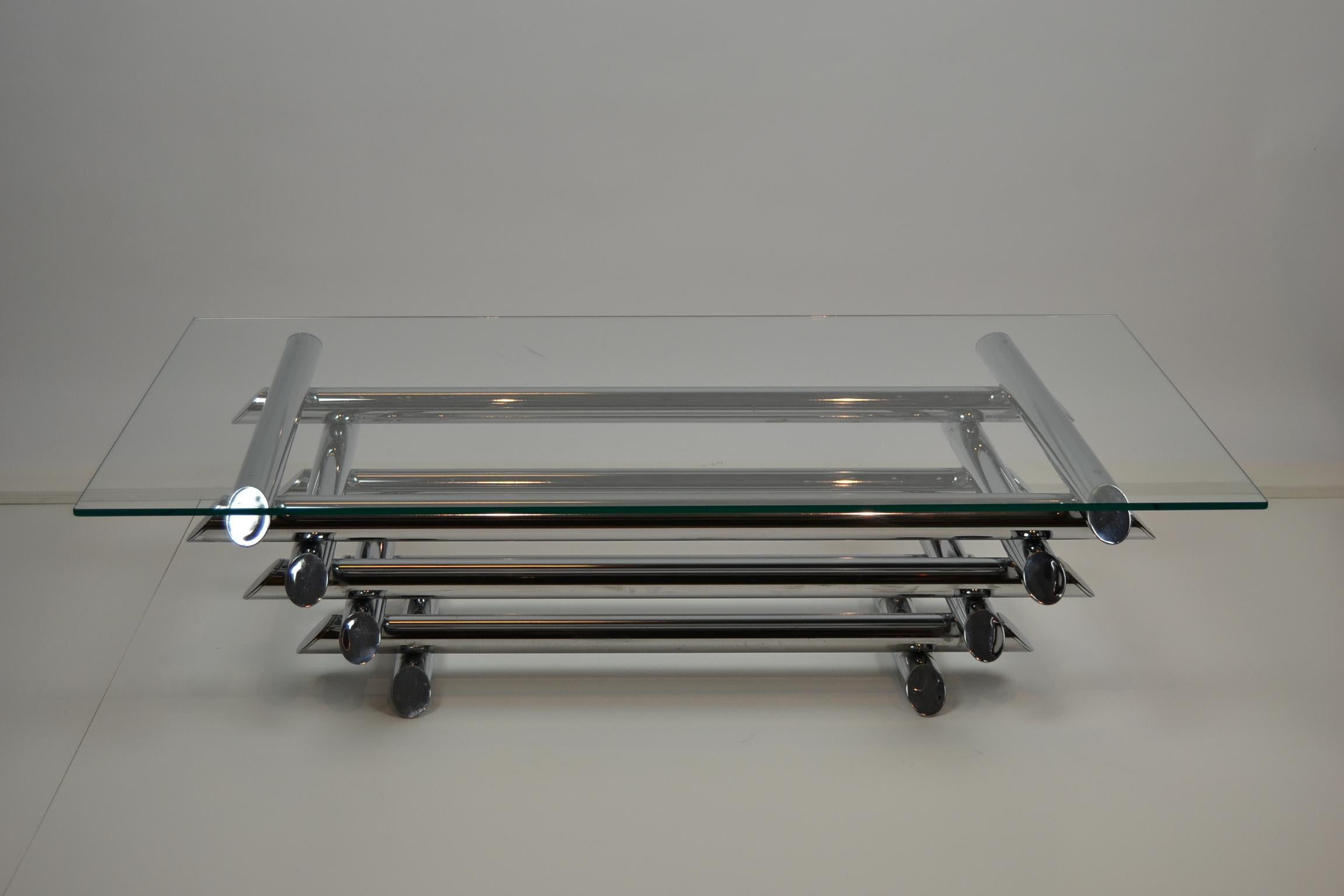 1970s French Chromed Tubular Steel Coffee Table. 
This Mid-Century Modern Low Table has 4 layers of chromed metal tubes 
with a thick glass on top. 

The Chrome of the coffee table base is still in very good condition, 
only on the bottom ( the part