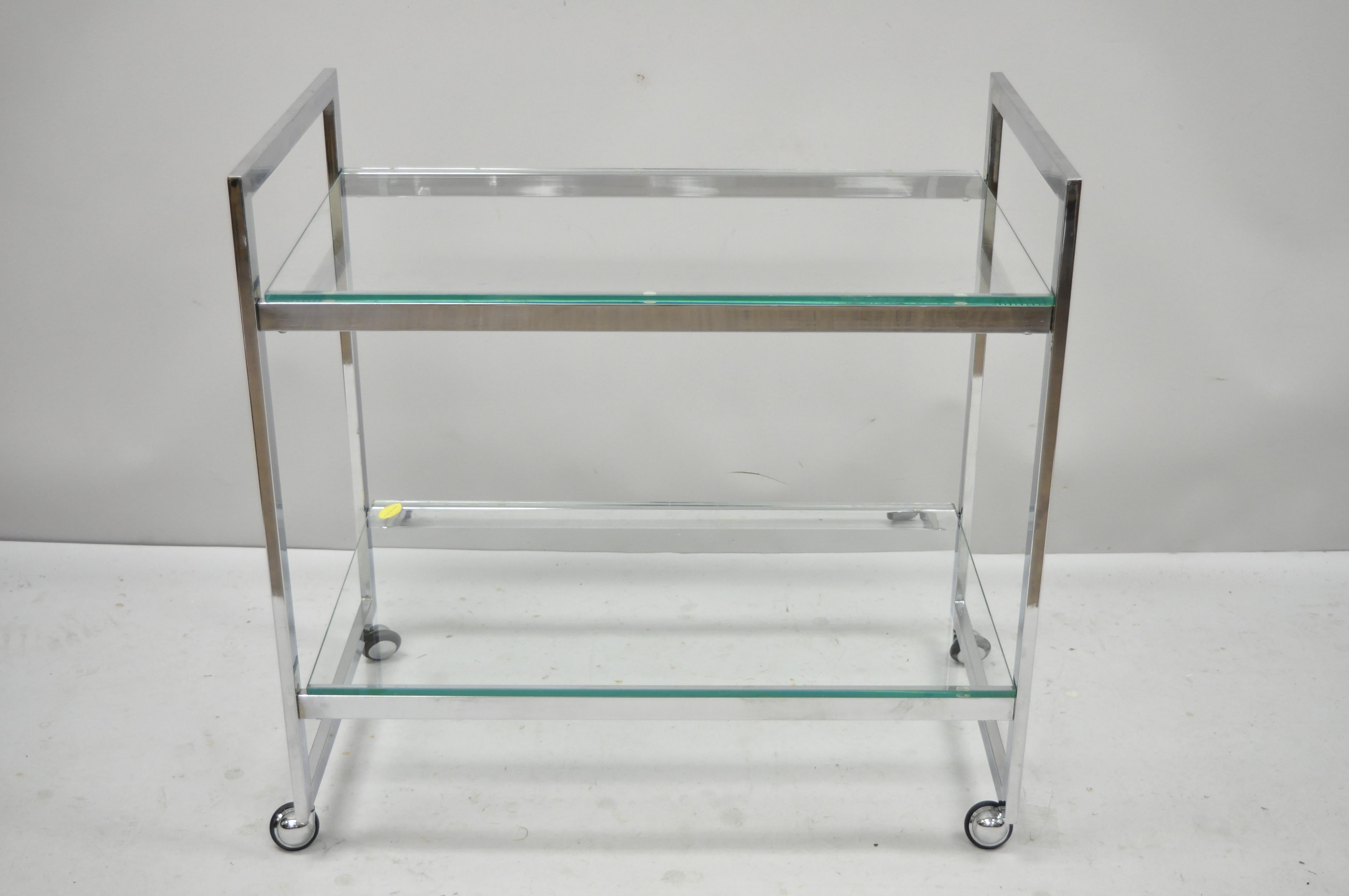 Vintage Mid-Century Modern chrome two-tier glass shelf rolling bar tea cart by Herver Jumet in Belgium for Glassland. In the manner and quality of Milo Baughman for design institute of American. Item features rolling casters, chrome 2 tier frame,