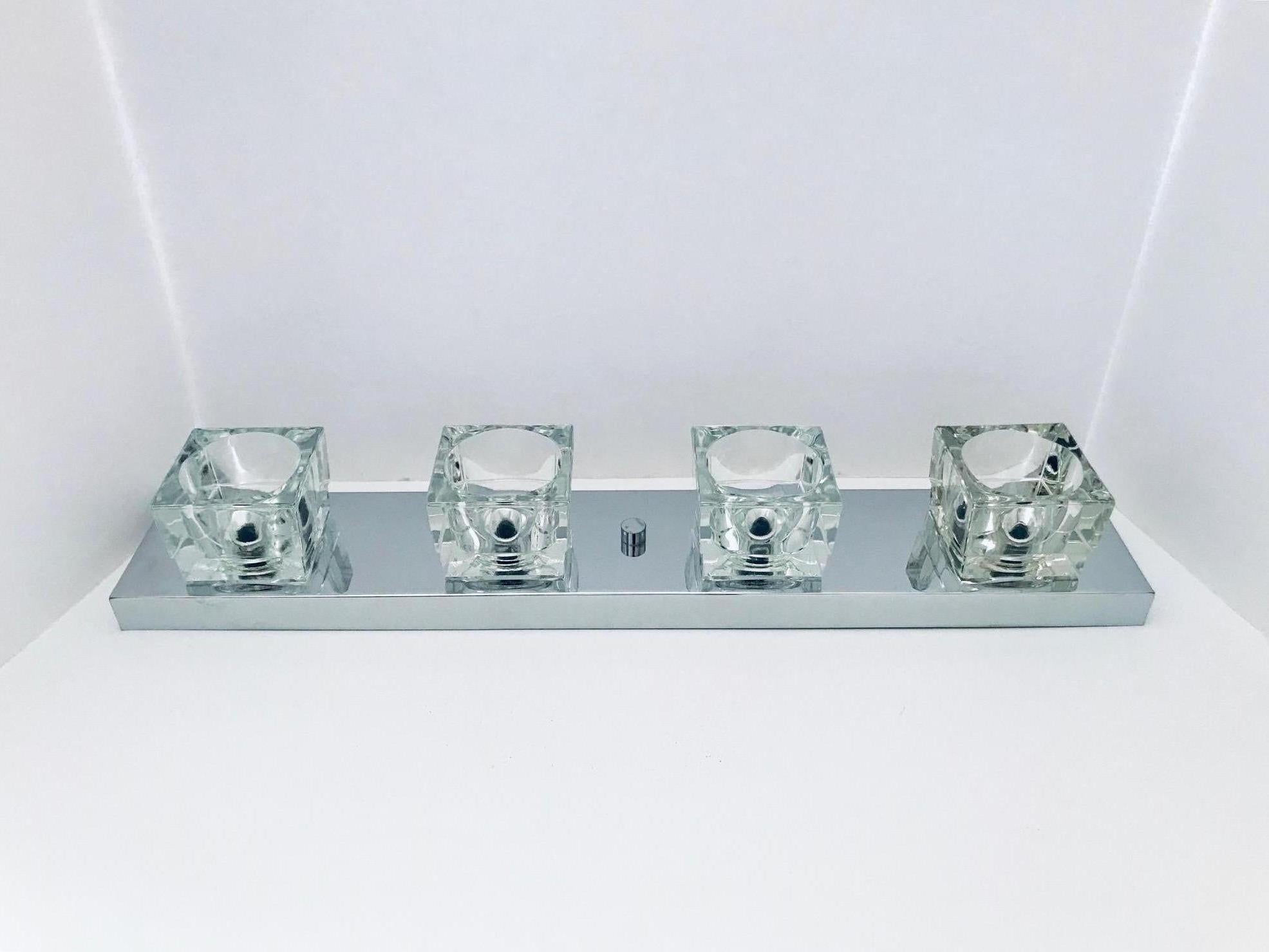 Italian Mid-Century Modern sconce featuring four molded glass block shades. Cubist design in polished chrome with chrome centre finial. Can be is mounted vertically or horizontally. Newly re-plated in chrome.
Makes great powder room vanity light.