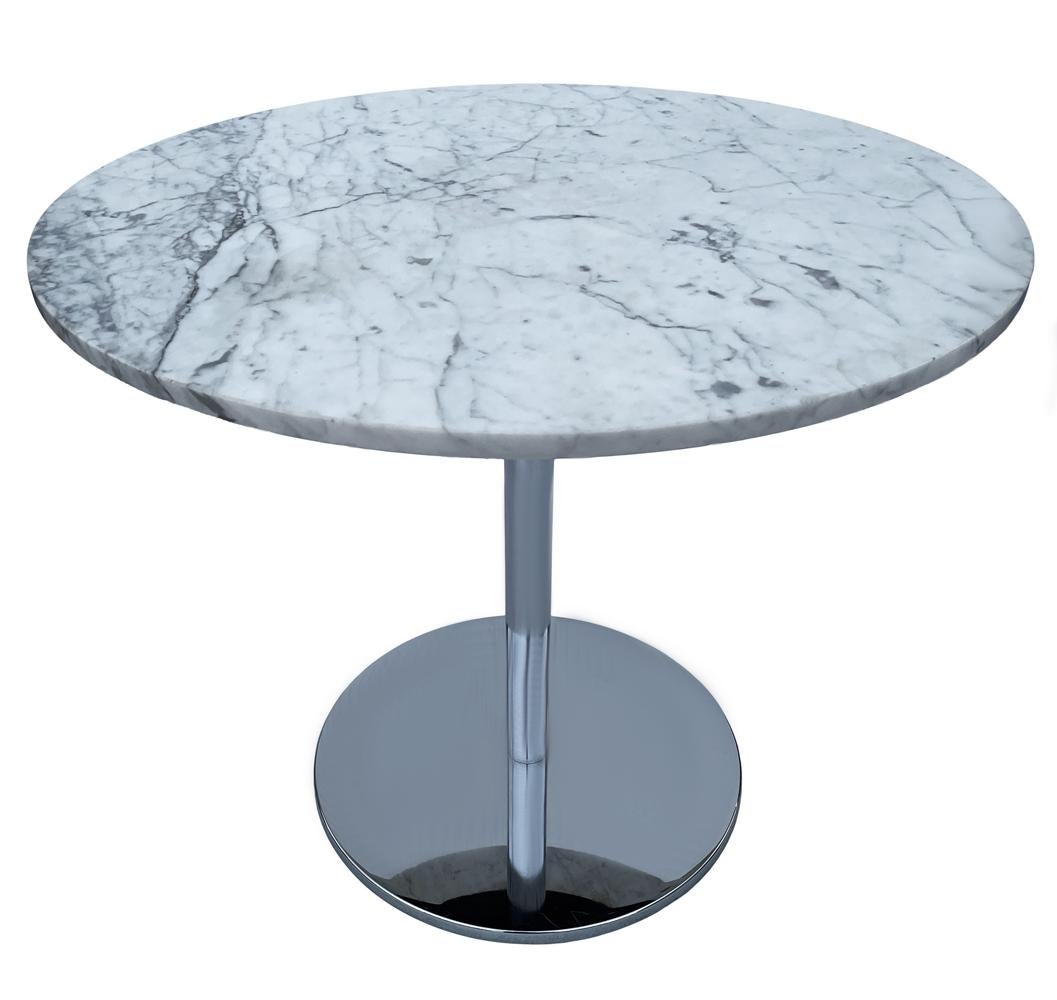 This 1970's table is extremely heavy and well made. It features all chrome weighted base with white and grey round marble top.