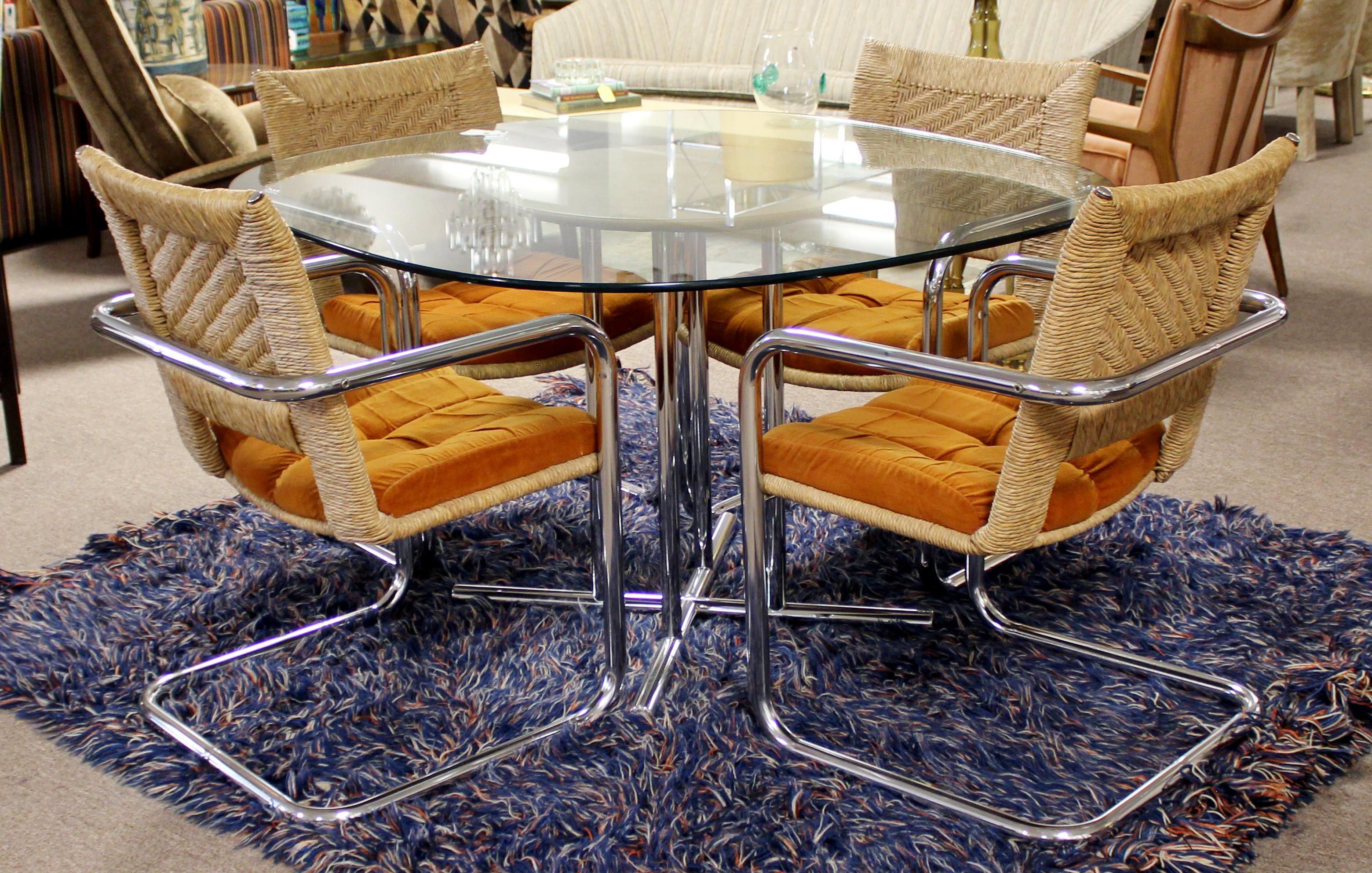 For your consideration is a timeless dining or dinette set, including table and four armchairs, by Chromecraft, circa the 1970s. Table has a chrome base, with a beige leather insert and glass top. The four armchairs are cantilevered chrome, with