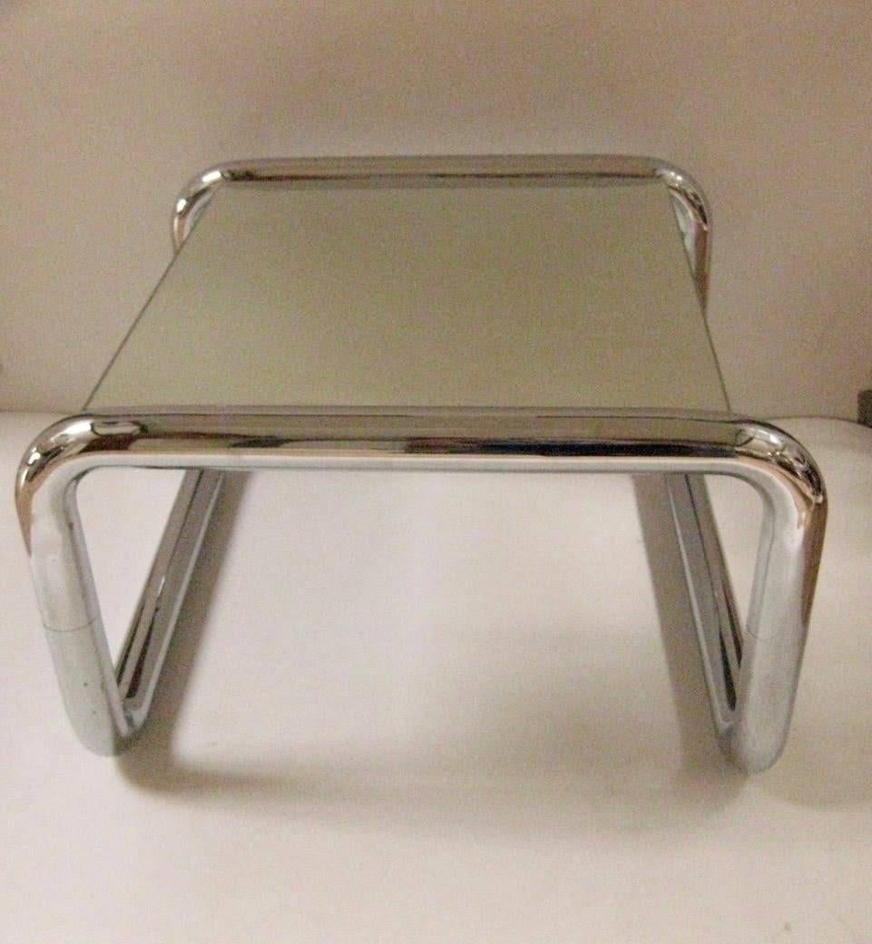 Mid-Century Modern chromed tubular metal side or end table with floating mirrored top. Table is composed of 2.5” round tubular chromed metal frame with mirrored glass top.