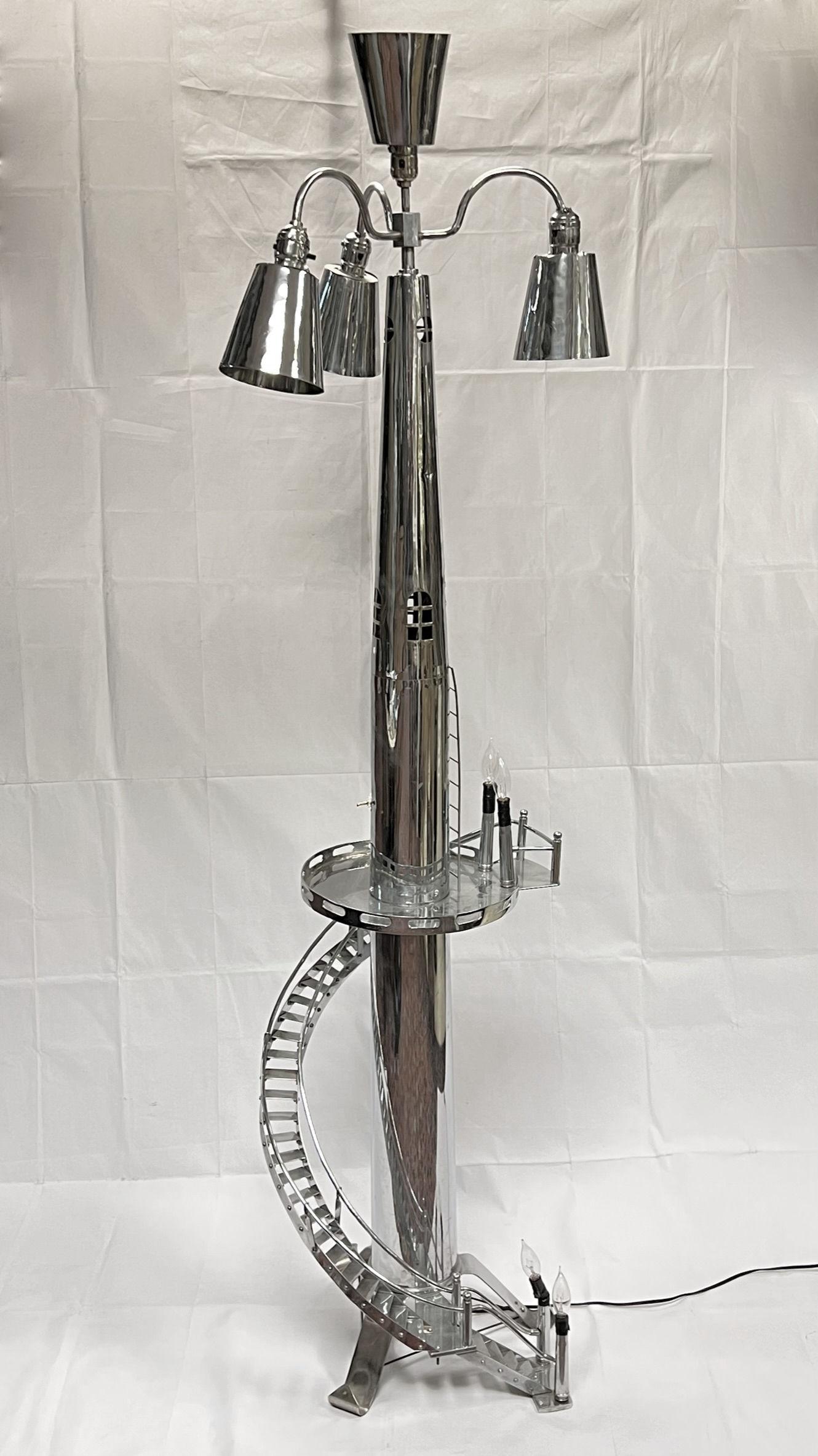 This most unusual mid-century modern chrome plated floor lamp has the form of a tower with spiral staircase, with single standard socket at top with three sockets and shades pointing downward with push button on/off switches, and two pairs of