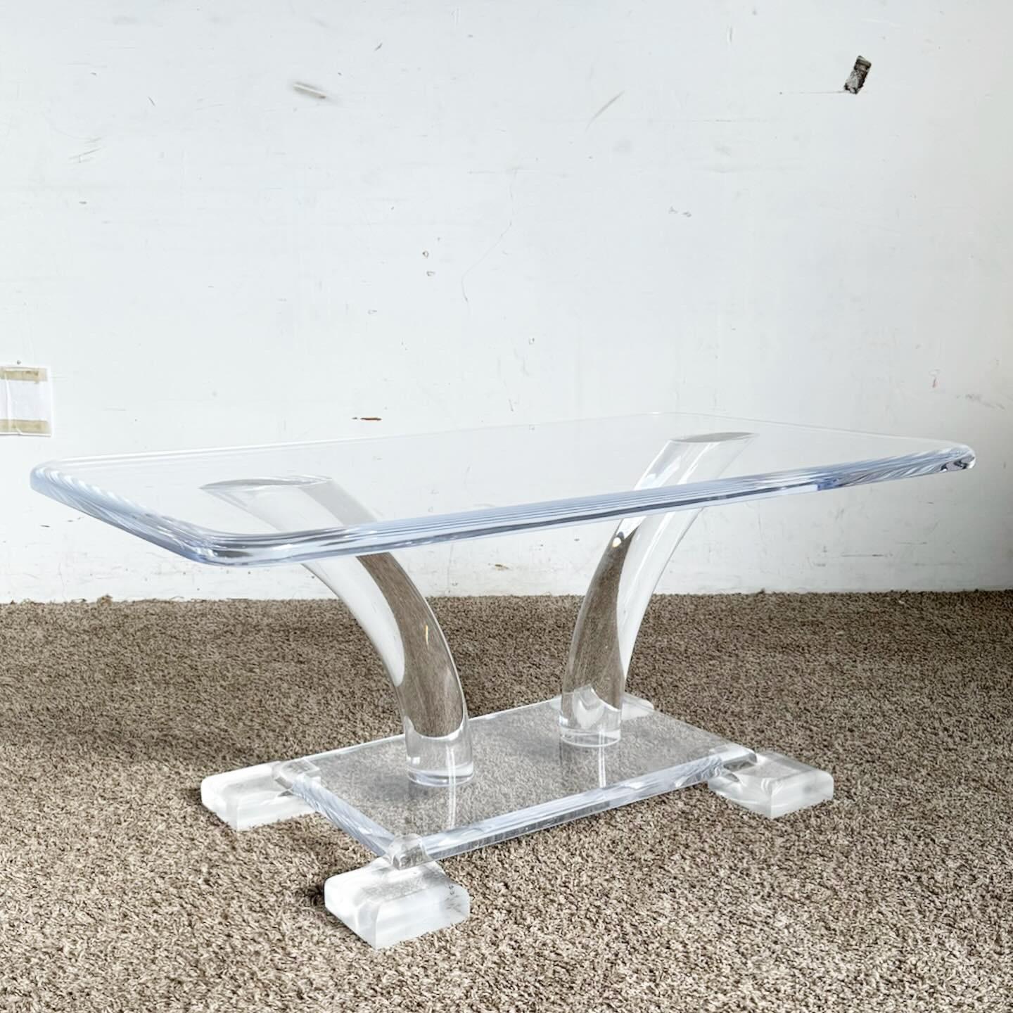 The Mid Century Modern Chunky Lucite Coffee Table adds a retro yet futuristic touch to any interior. Made entirely of lucite, it features a bold, minimalist design. Its transparency creates a light, floating appearance, making it versatile for