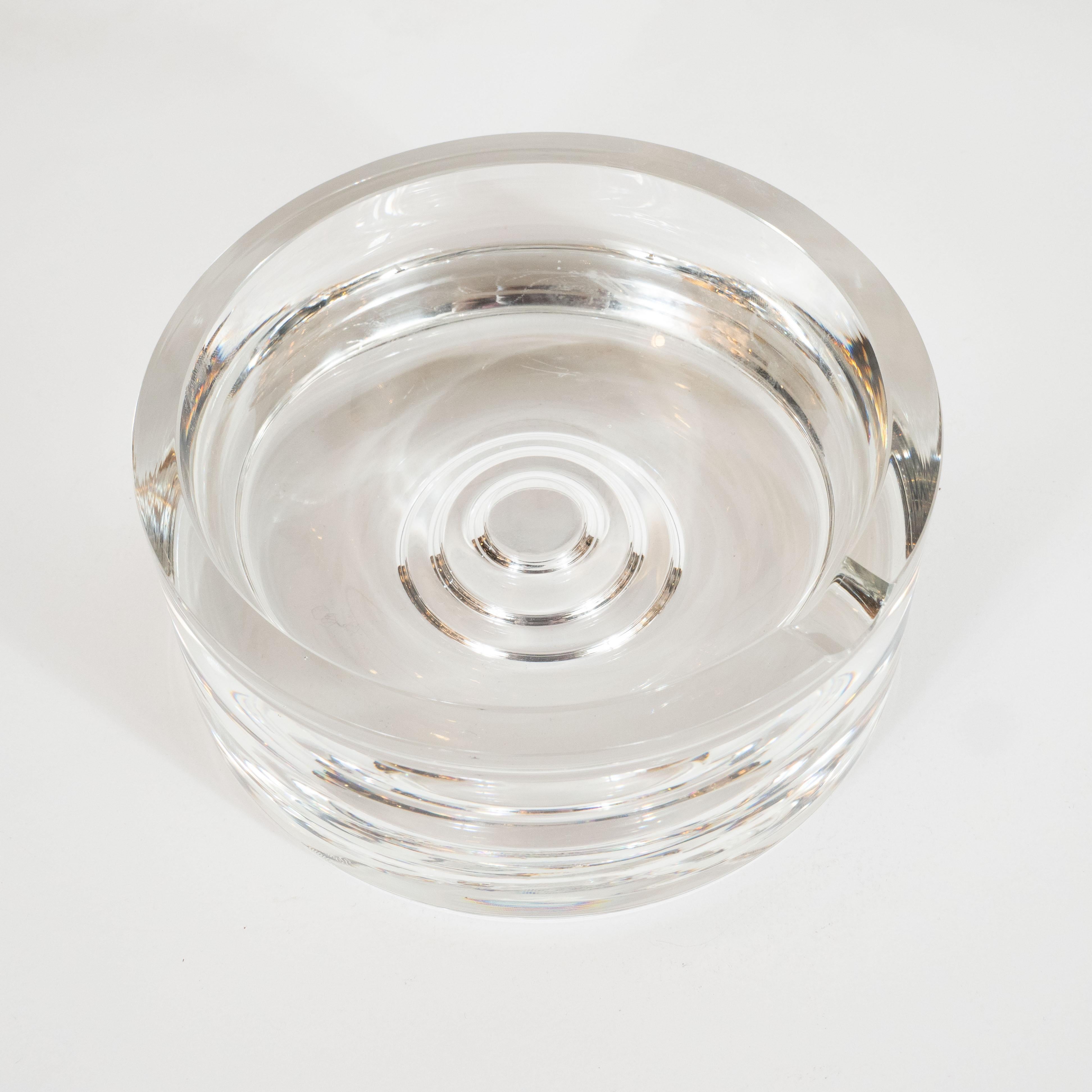 This elegant Mid-Century Modern ash tray was realized by Rosenthal- one of the world's premiere makers of crystal products- in Germany, circa 1970. IT features a circular form- a design motif that is reiterated in the recurring concentric shapes