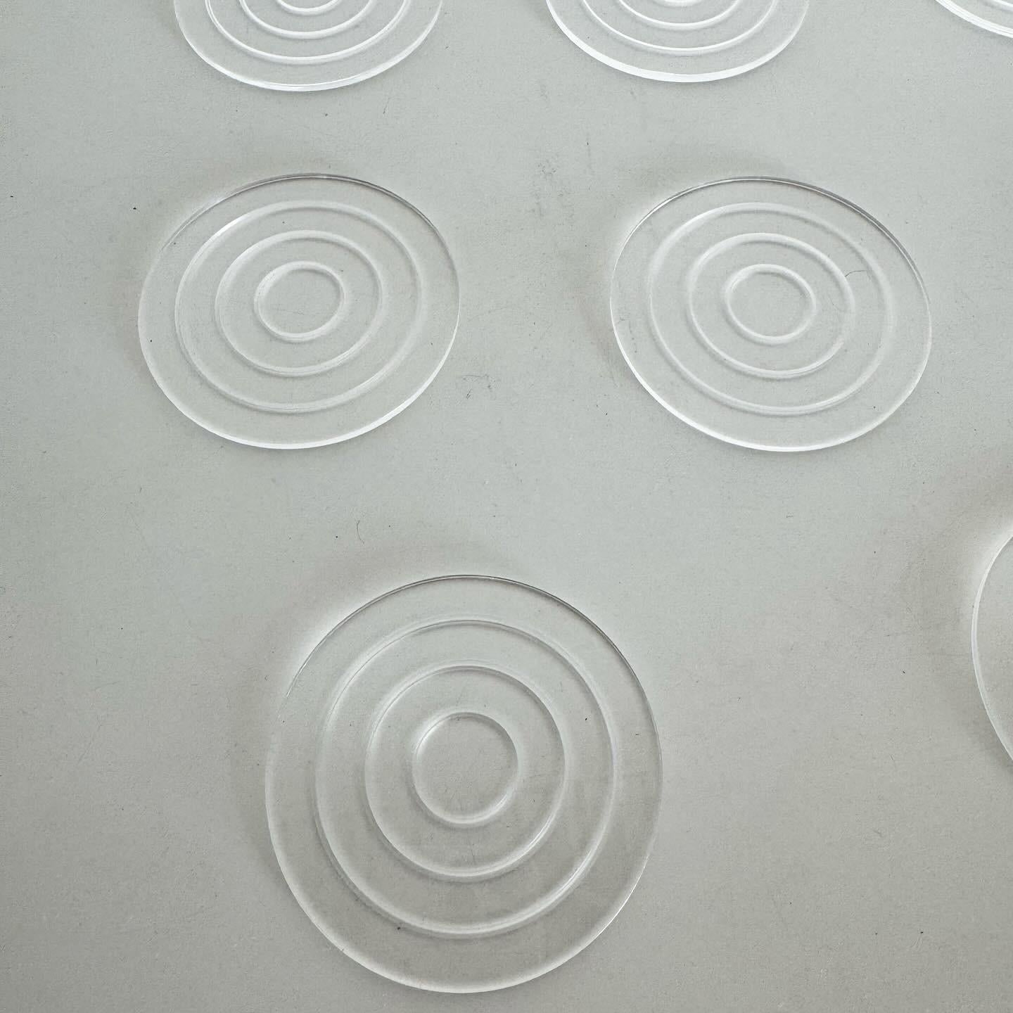 Experience the minimalist elegance of Mid Century Modern with a set of 8 circular Lucite coasters, blending iconic design with functionality. These coasters are not just a practical accessory but also a statement piece that reflects the innovative