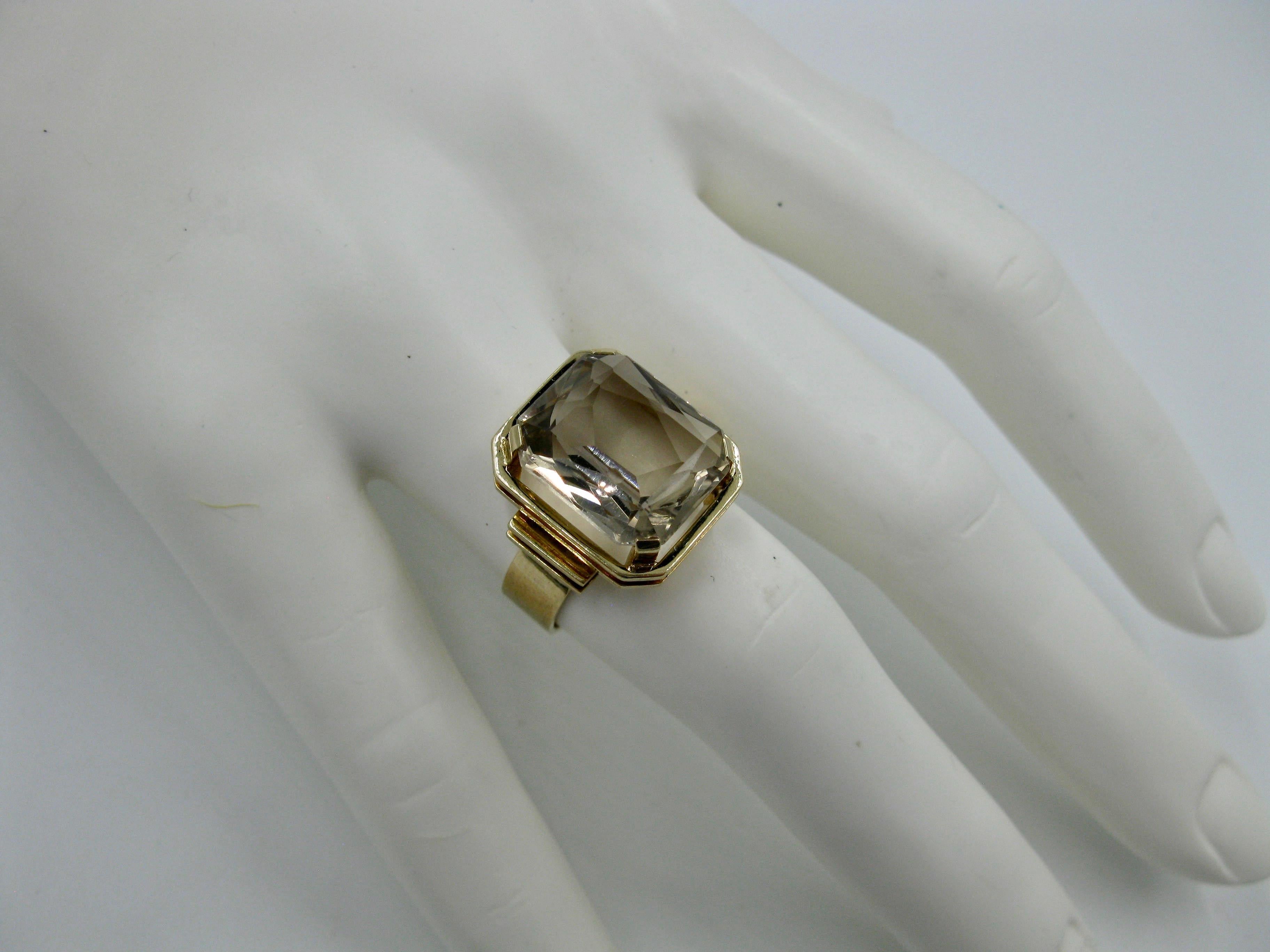 The stunning emerald cut Citrine 14 Karat Gold mid-century modern ring was made in Finland in 1960. A ring created by the esteemed Finnish Jewelry designers from the Mid Century Modern period in Scandinavia. The beautiful Citrine is emerald cut and