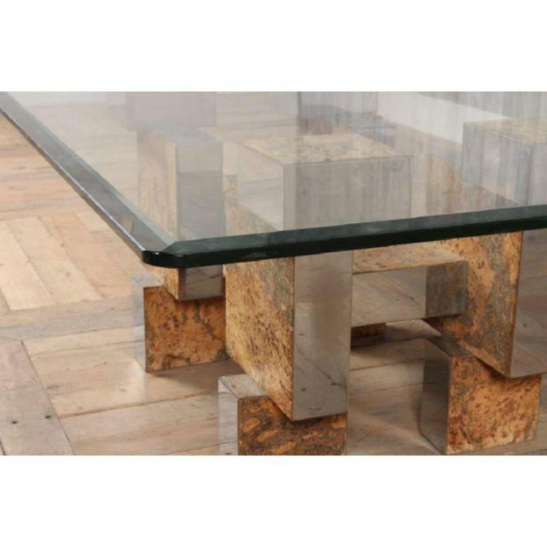 A beautiful architectural coffee table in the style of Paul Evans from the Cityscape series. The piece features Cubist forms and is finished in signature veneer patchwork of burled walnut and metal insets. The table has a square glass top with