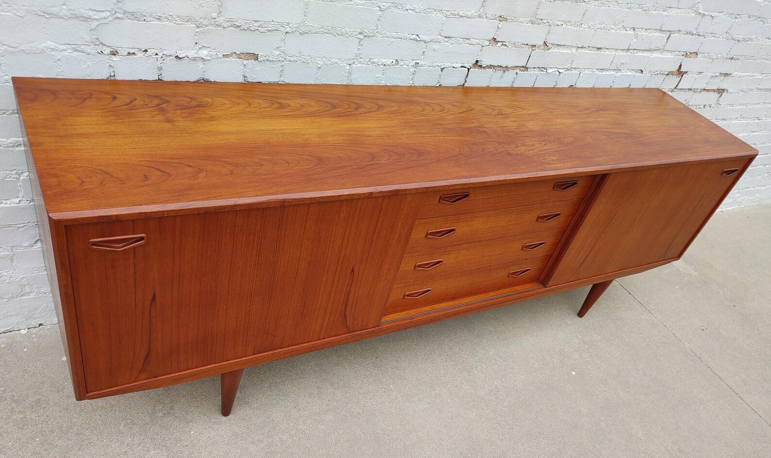 Mid Century Modern Clausen and Son Teak Credenza

Above average vintage condition and structurally sound. Has some expected slight finish wear and scratching.  Has some discoloration on top from refinishing. Please request additional pictures.
