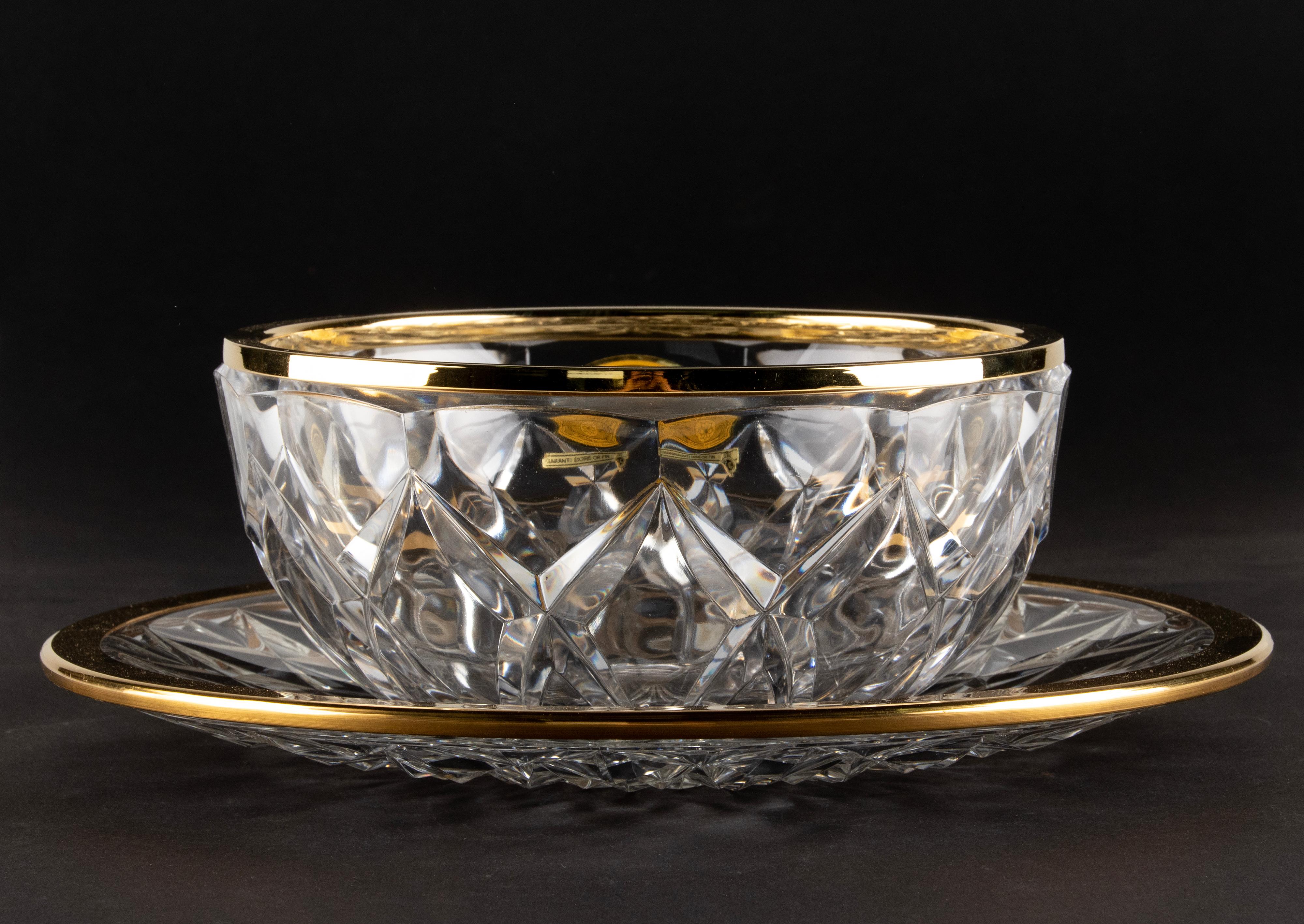 Beautiful crystal bowl made by the Belgian brand Val Saint Lambert. 
The bowls is made of clear crystal with nice carvings and a gold colored metal ring. 
The bowl and the plate are both signed on the bottom. 
In very good condition. 
