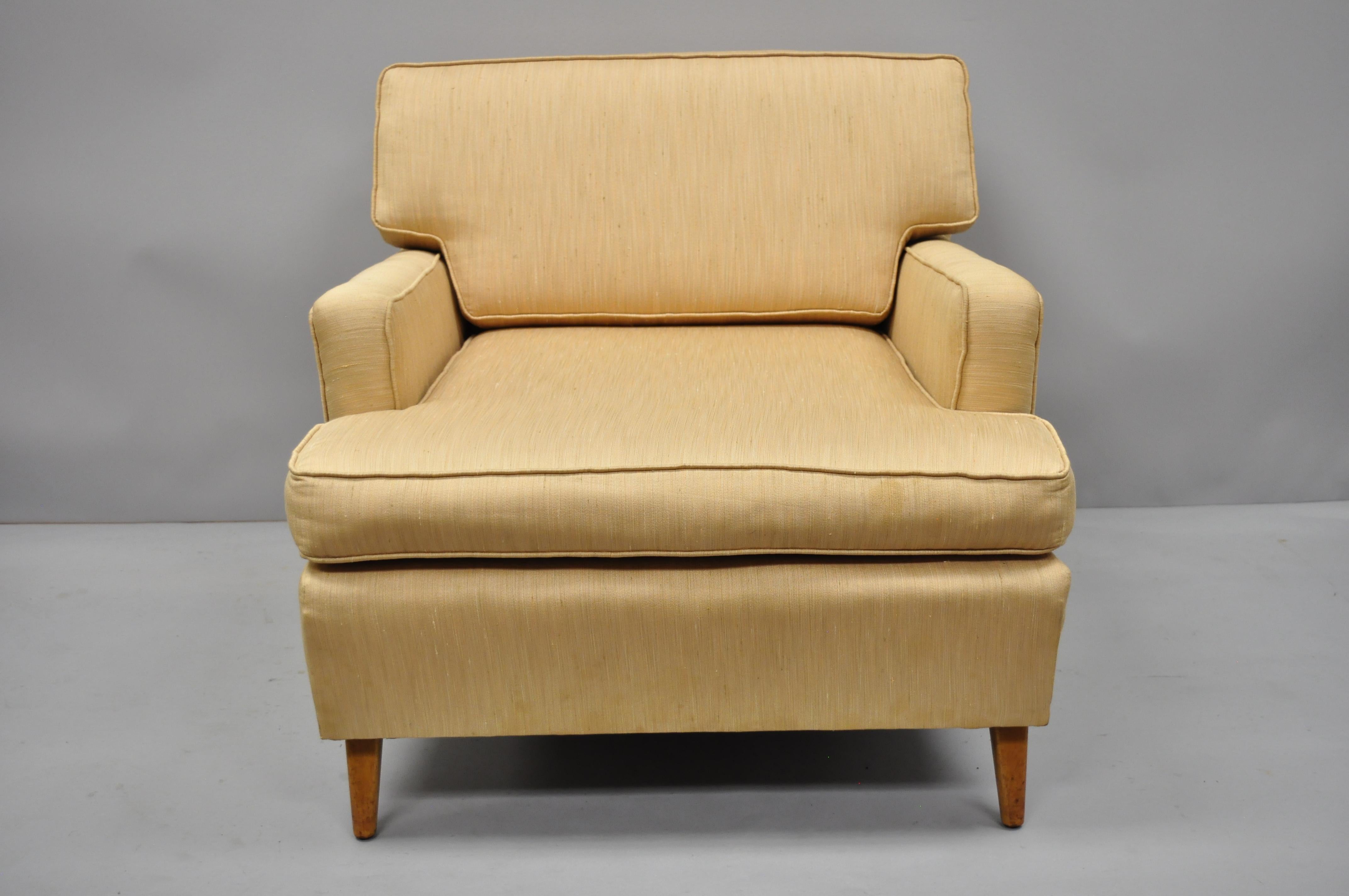 Mid-Century Modern upholstered club lounge chair after Paul McCobb and Harvey Probber. Item features angled and tapered legs, nice comfortable form, solid wood frame, tapered legs, clean modernist lines, and sleek sculptural form. Possibly by Paul