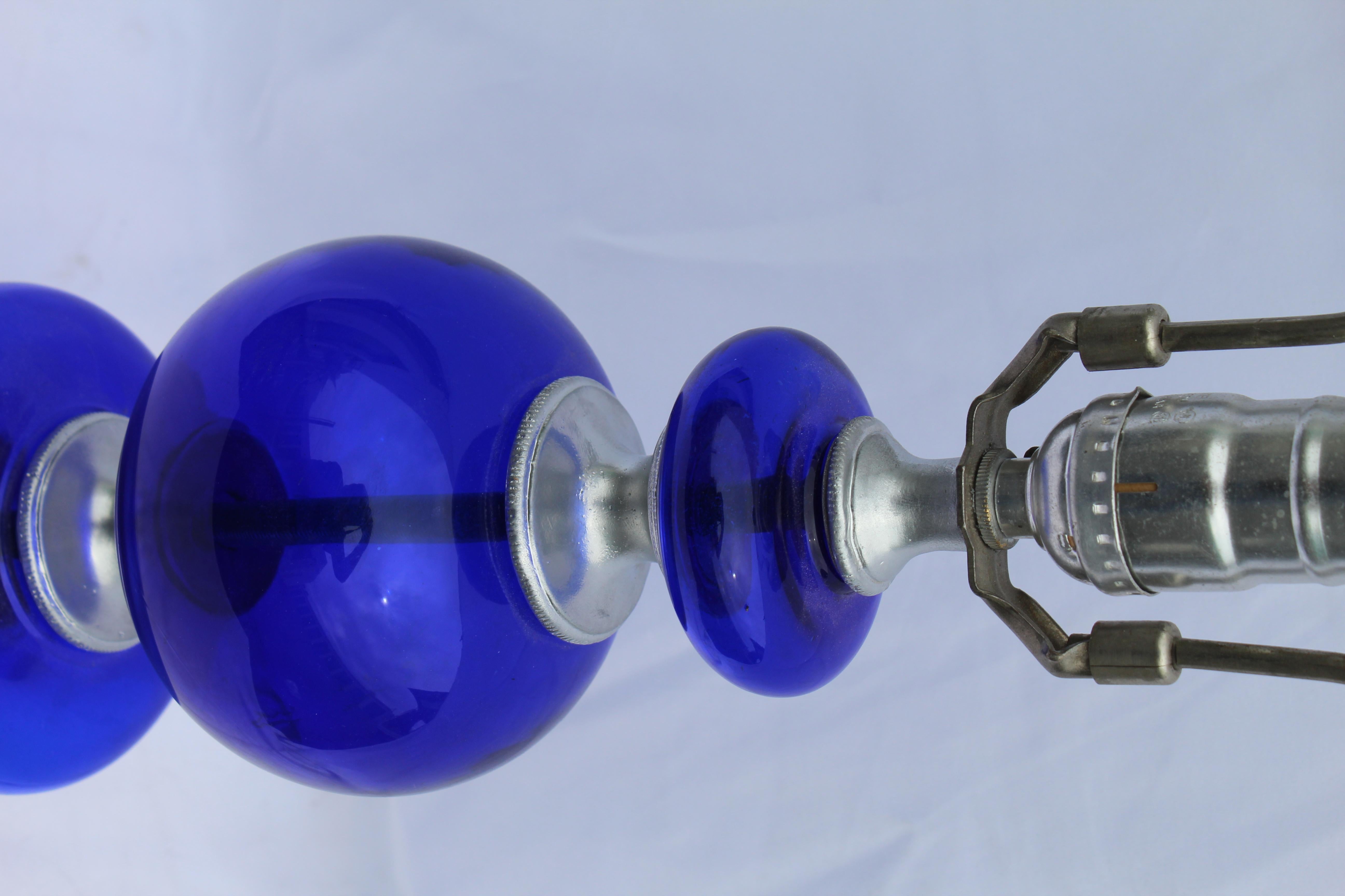 Custom designed cobalt blue glass orbs and balls that were designed by an Interior designer in Los Angeles. The glass spacers are cast bronze and the metal base are all with a painted Silver finish . Has an Edison socket and 10