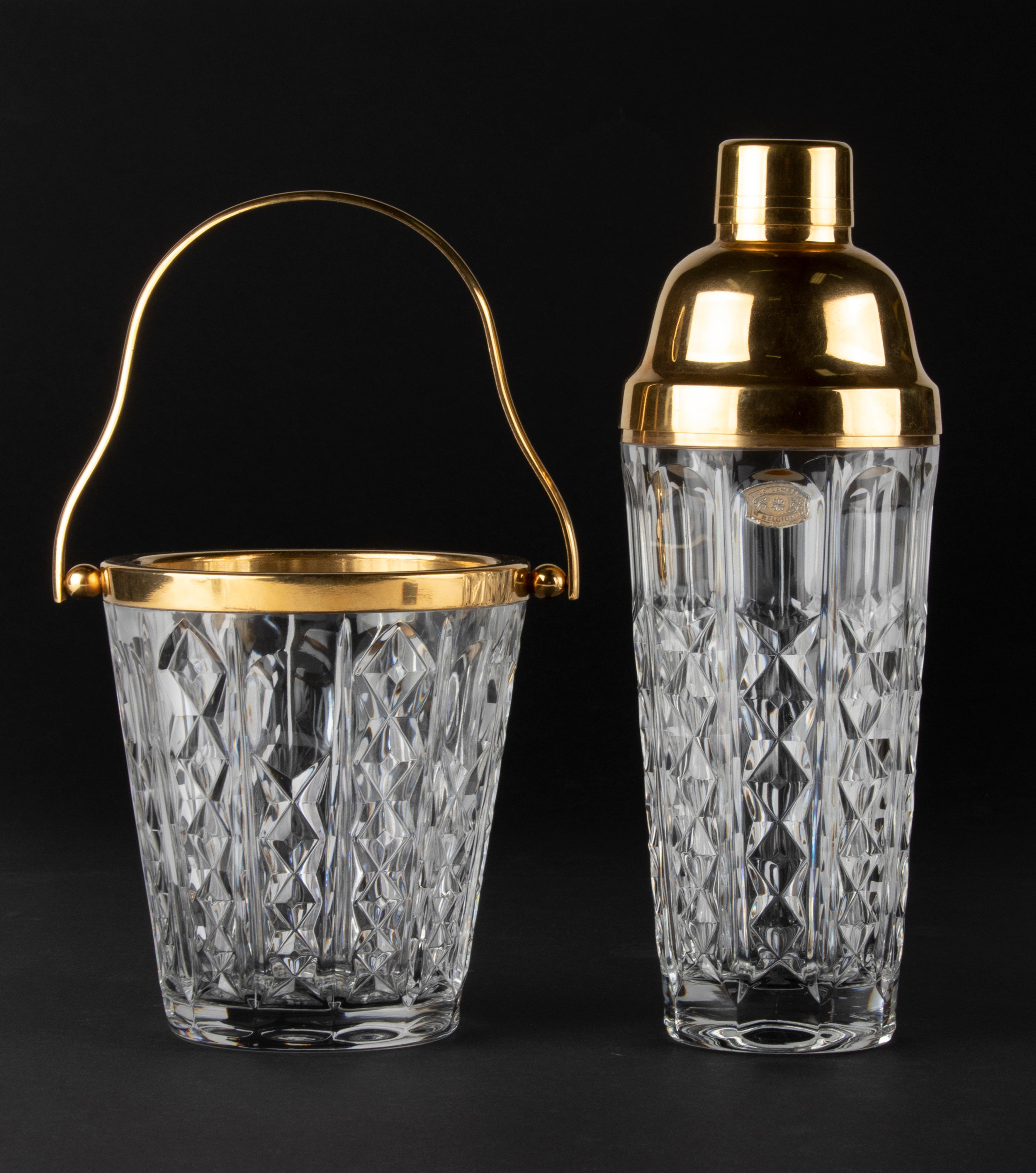 Vintage cocktailshaker with matching ice cube bucket. Made of clear crystal, decorates with gold colored metal rings. Both are signed Val Saint Lambert on the bottom. 
In very good condition. 
Measures: The shaker is 27 cm tall and Ø9 cm, the