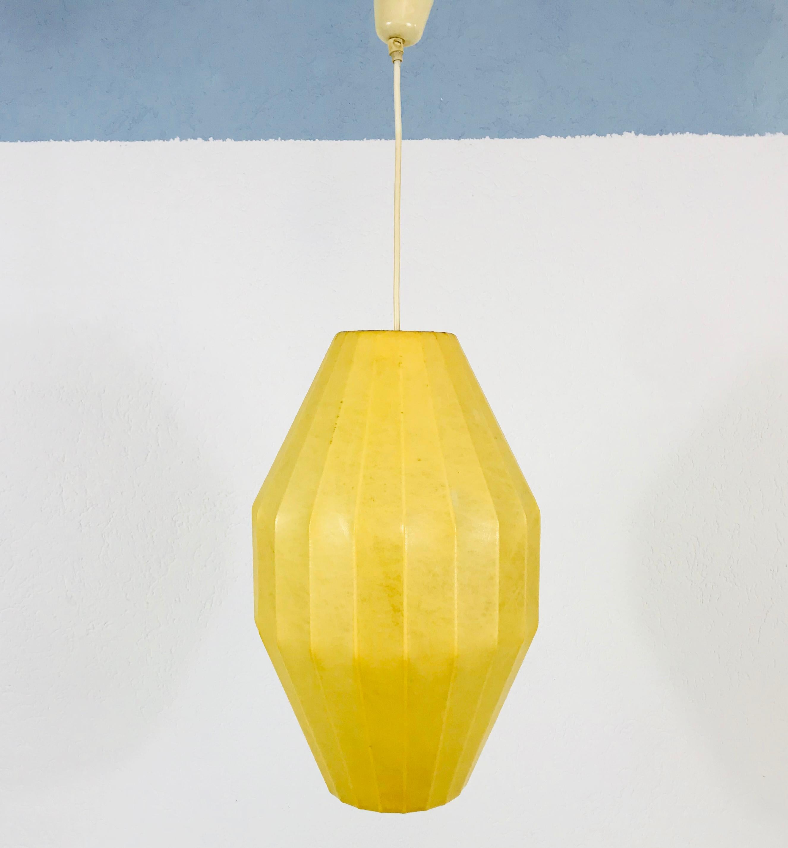 A cocoon hanging lamp made in Italy in the 1960s. It has a beautiful round design, which is similar to the lamps made by Castiglioni. 

The light requires one E27 light bulb.
  