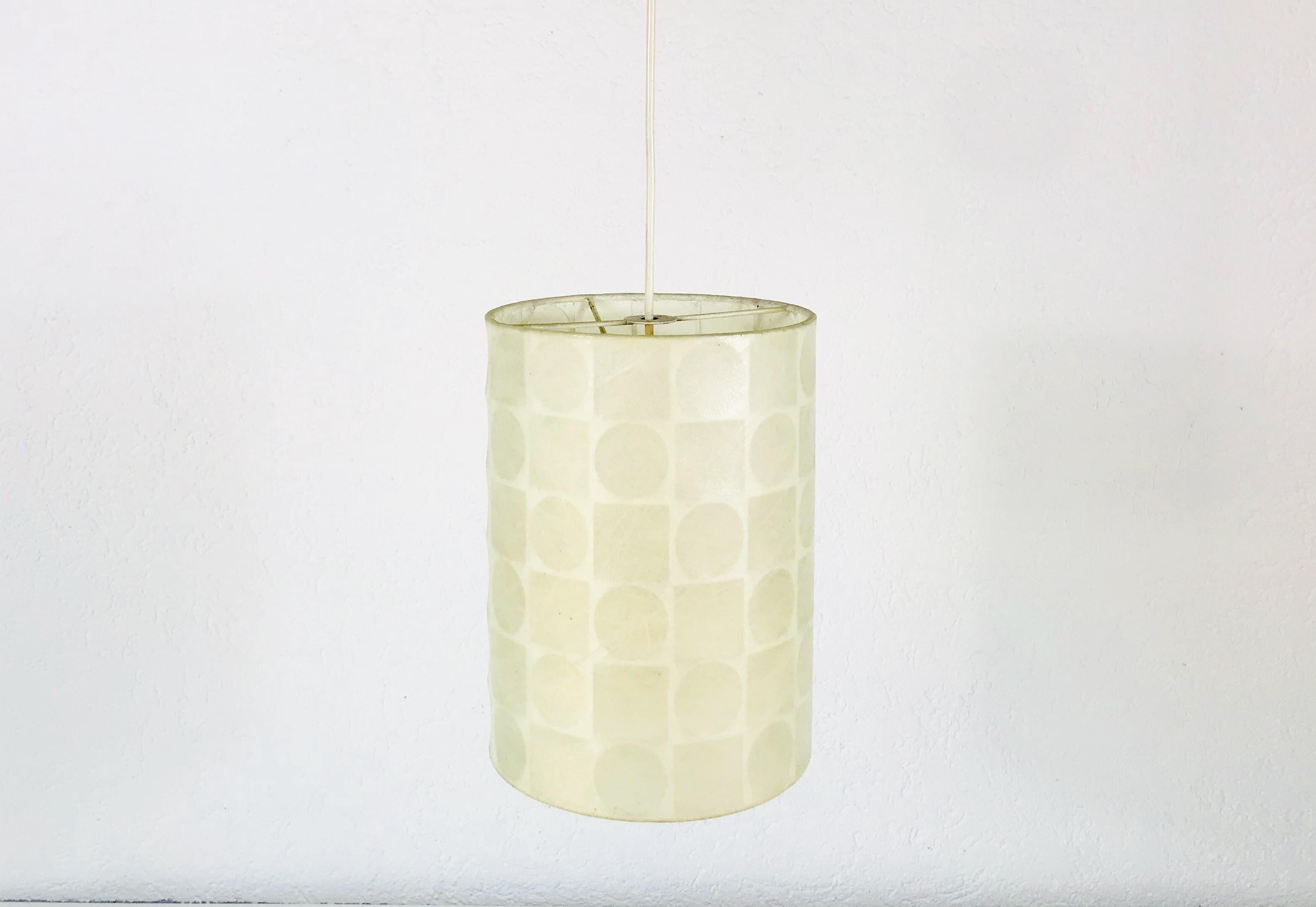 A cocoon hanging lamp made by the german brand Goldkant in the 1960s. It has a beautiful cylinder shape, which gives an extraordinary light.

The light requires one E27 light bulb.
  