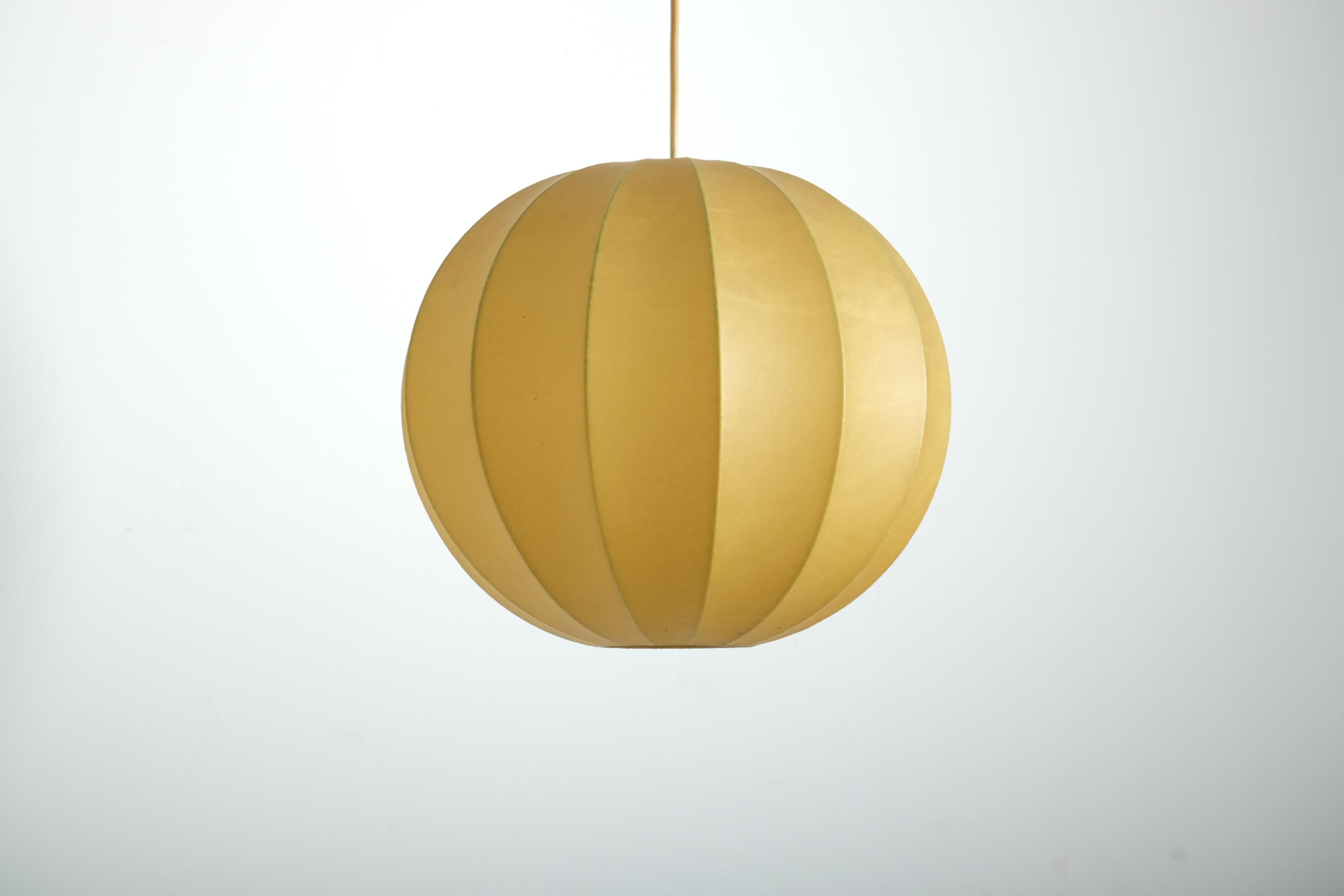 A Cocoon ceiling lamp made in Italy in the 1960s. The ceiling lamp was made in the design of the lamps by Achille Castiglioni.

The lampshade is made of resin. Very good vintage condition with no damage.

One E27/E26 bulb is required for the lamp.