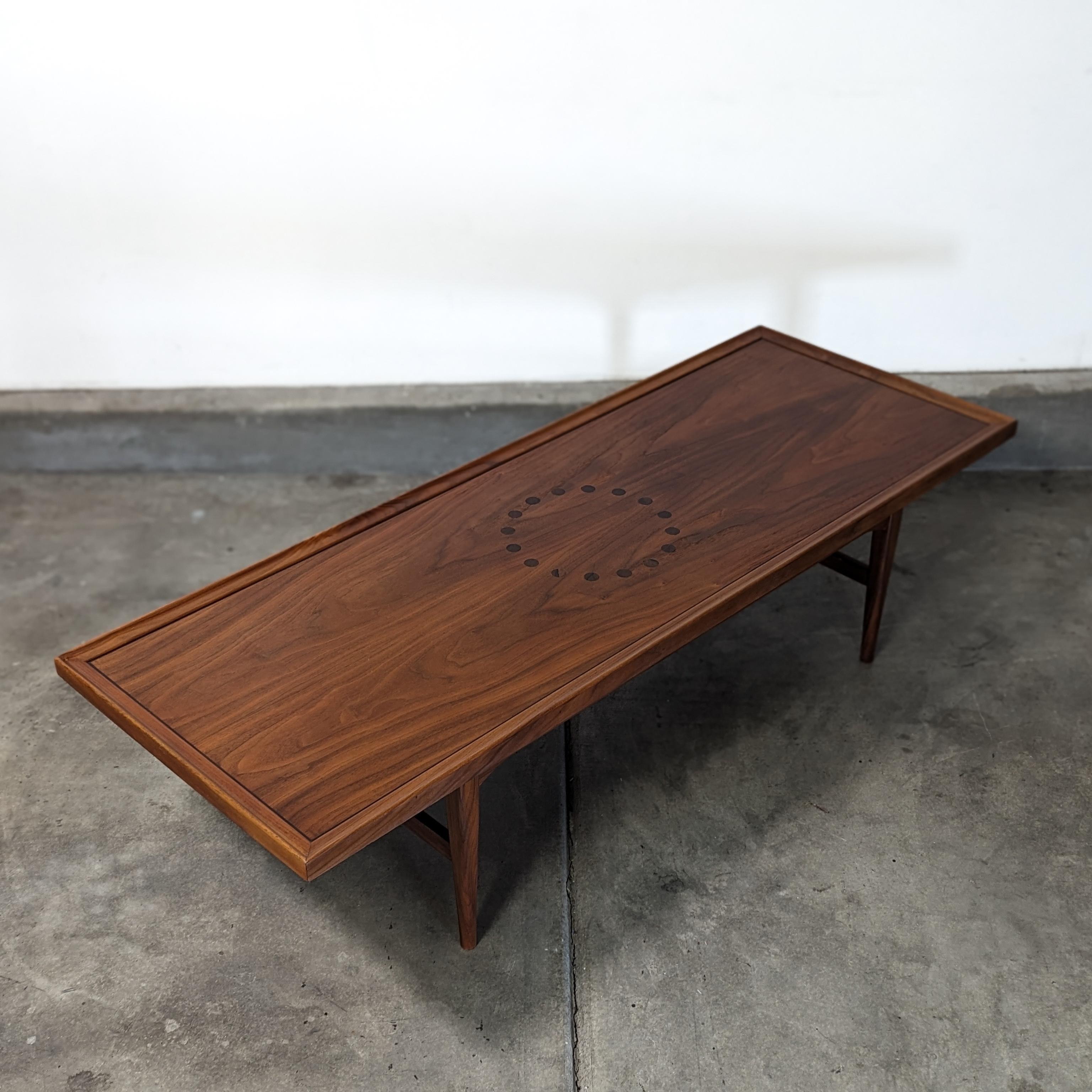 Step back in time and elevate your living space with this stunning vintage coffee table, a true gem designed by Stewart MacDougall and Kipp Stewart for the prestigious Drexel 'Declaration' line from the 1960s. This exquisite piece boasts a sleek