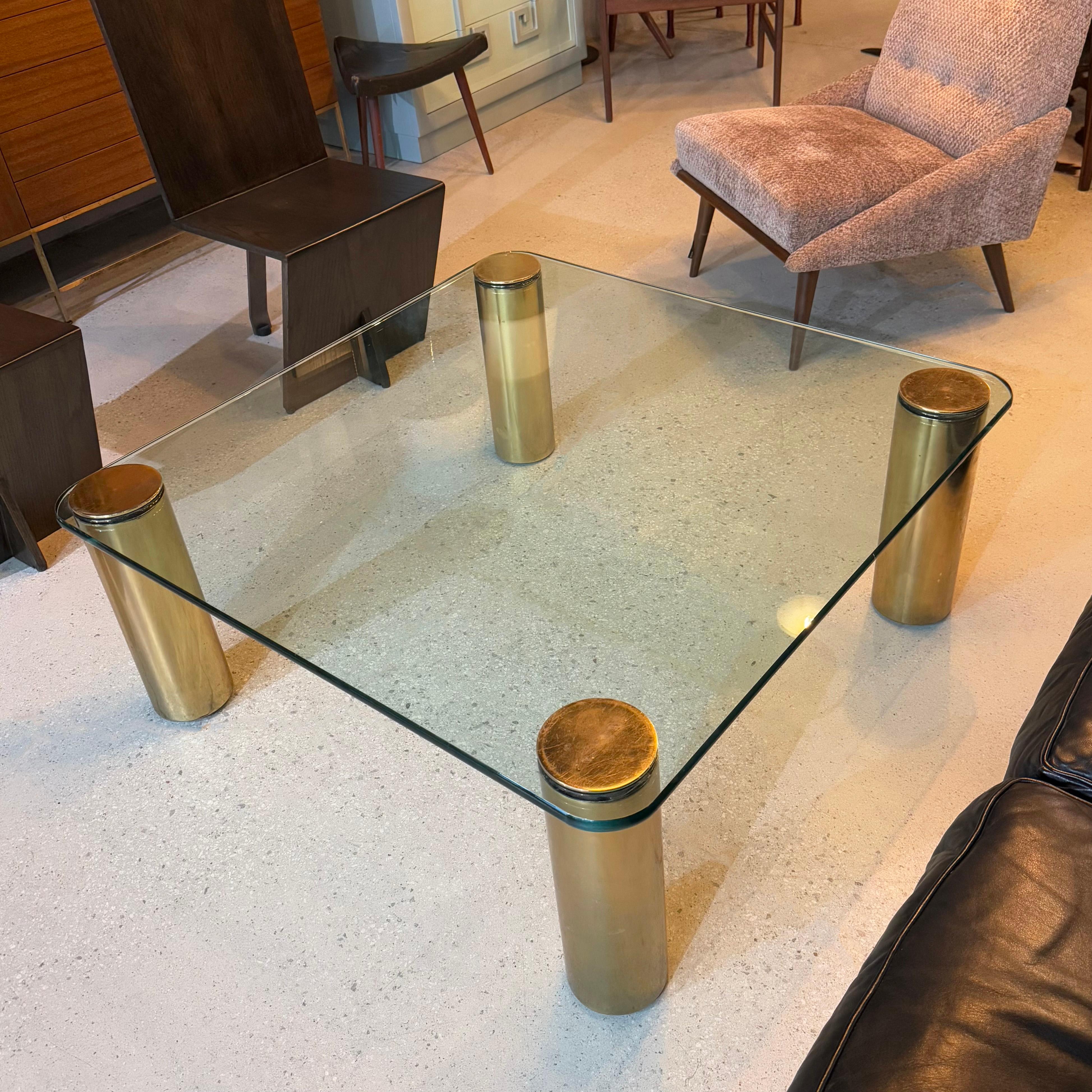 This stunning Mid-Century Modern coffee table was designed by Leon Rosen circa 1970s for the Pace Collection. It features four brushed brass 5