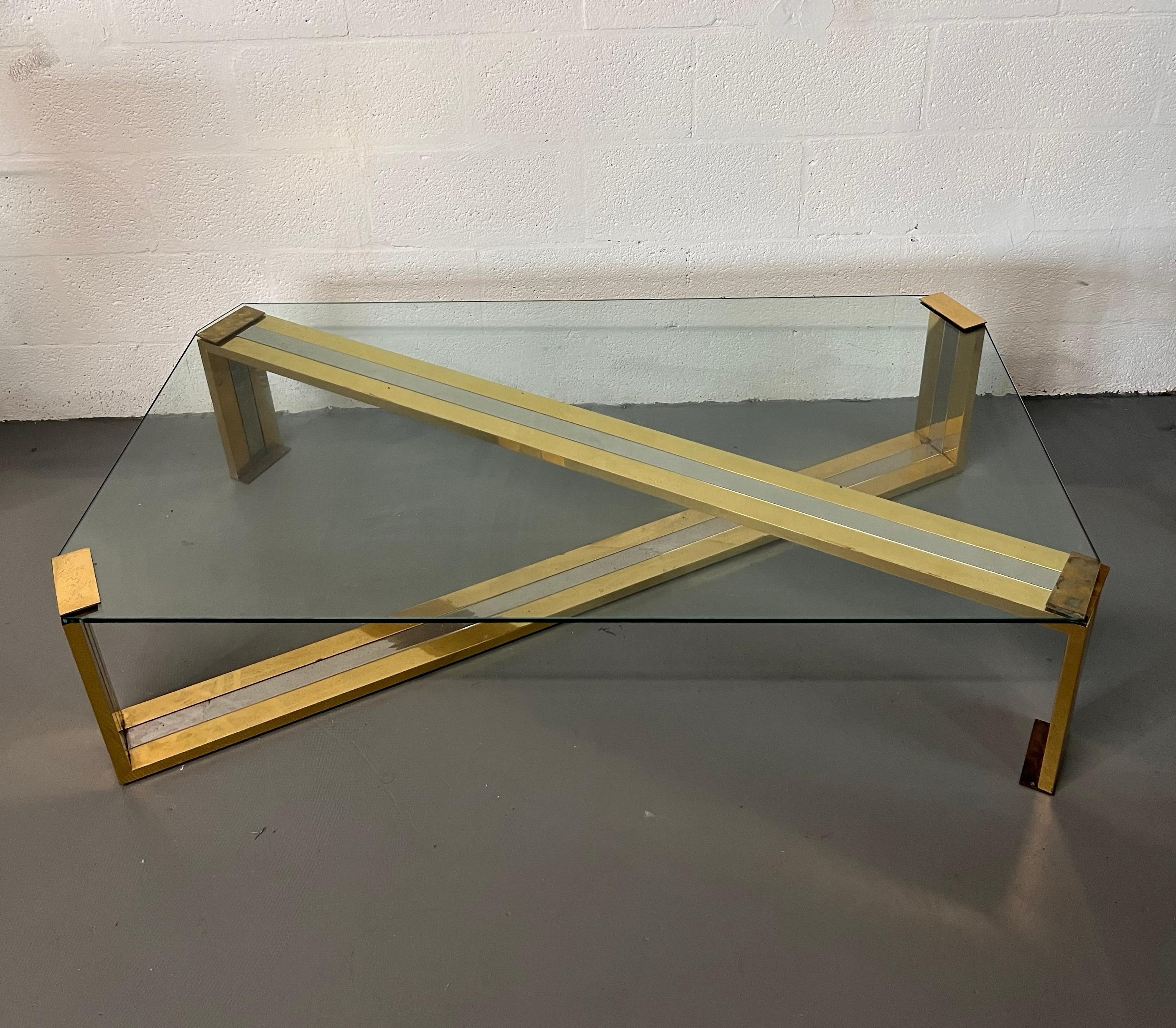 Large coffee table in polished Chrome and Brass  metalwork with thick glass top.
Mastercraft style
New York designer circa 1980