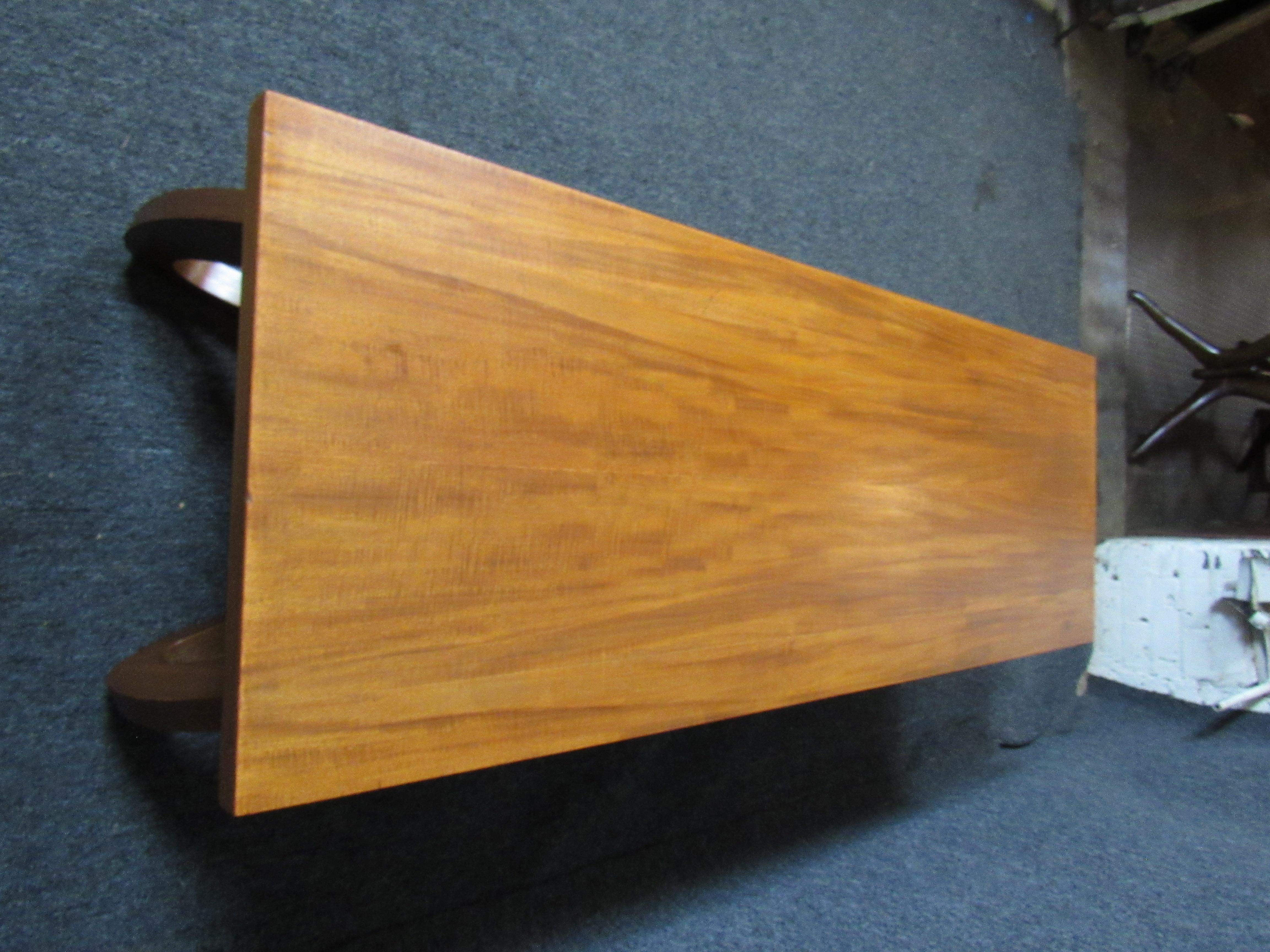 Long modern table with shelf and curled legs.
(Please confirm item location - NY or NJ - with dealer).
 