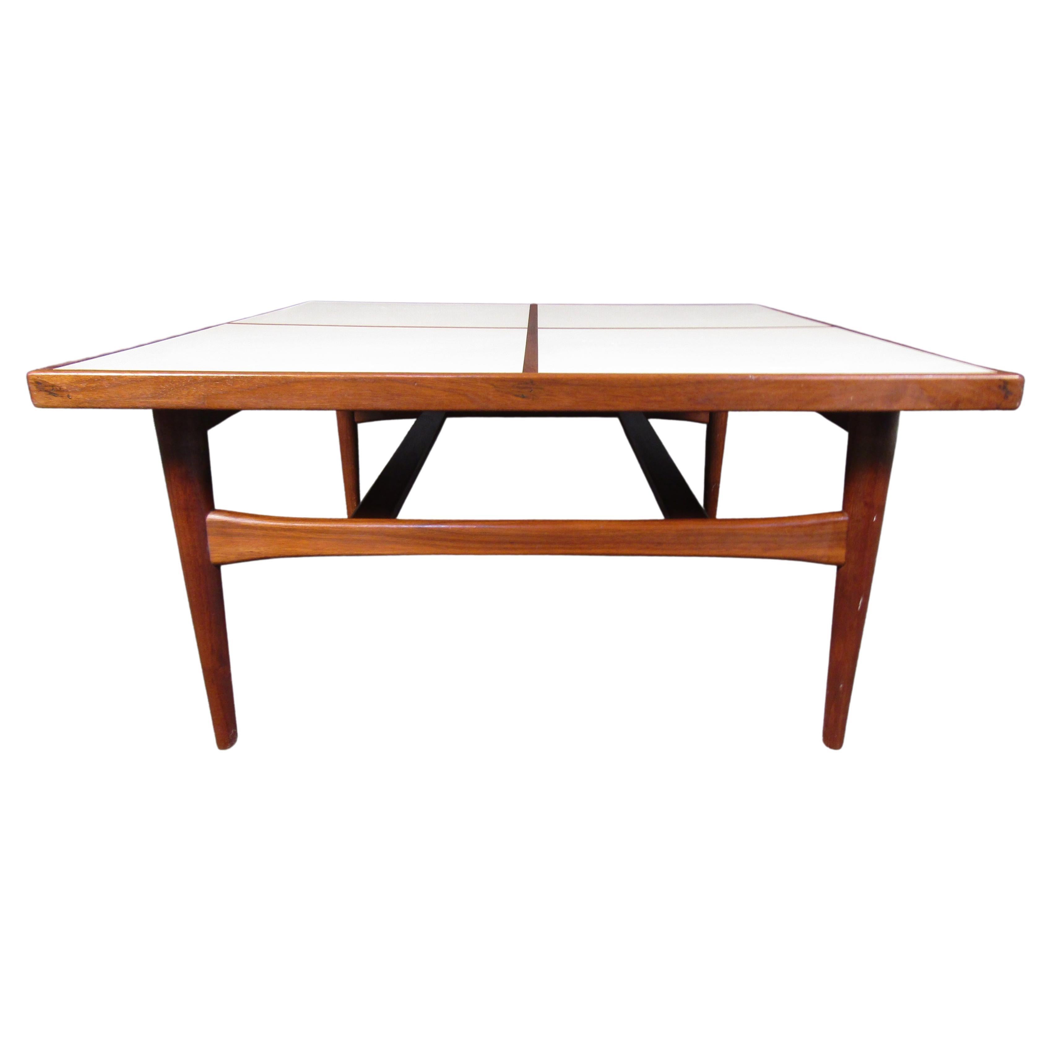 This vintage walnut coffee table is full of Mid-Century style, with a surface of contrasting white panels. Please confirm item location with seller (NY/NJ).
