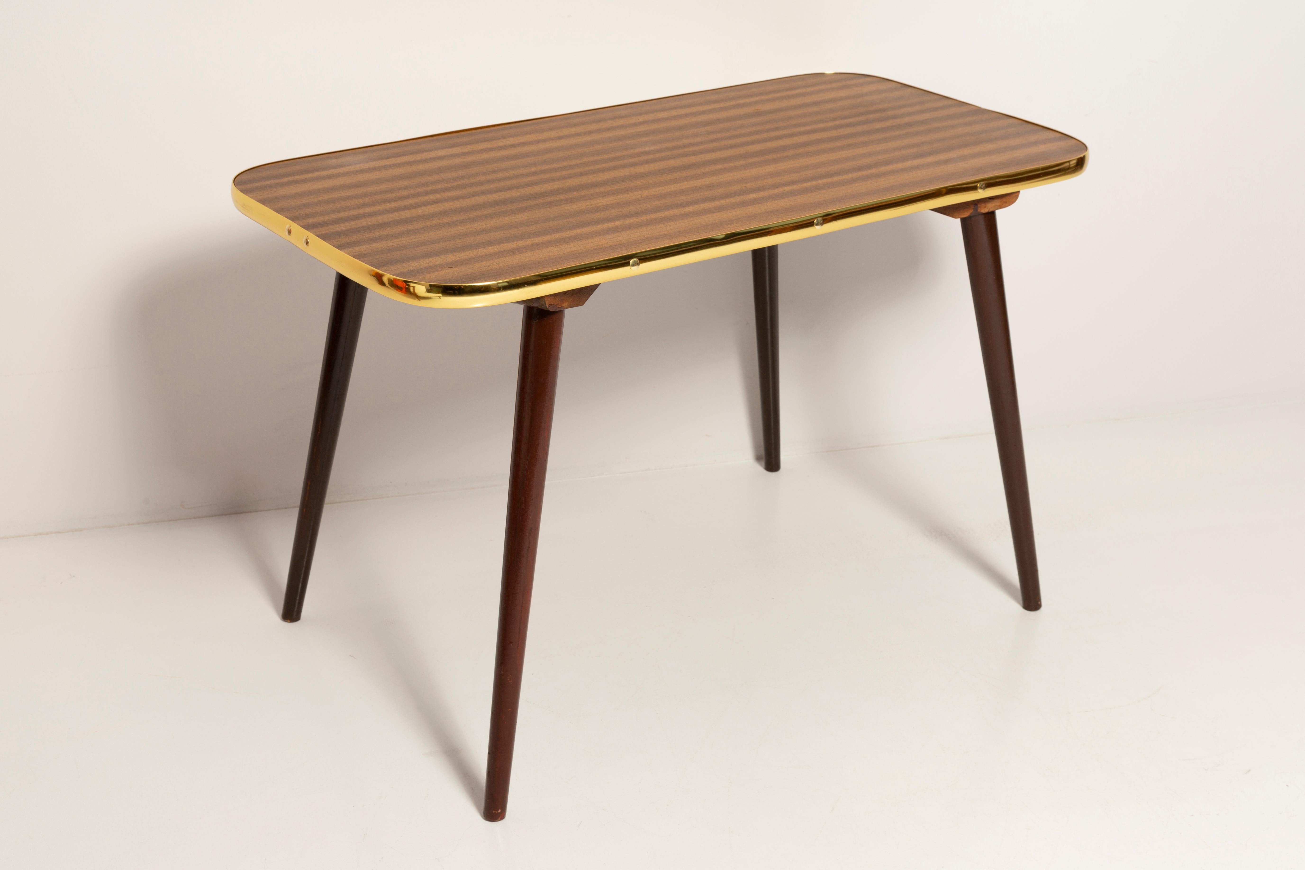 Coffee table from the 1960s. It was manufactured in Poland in 1960s. The table was made of wood and veneer plywood, it was refreshed. Original vintage condition.