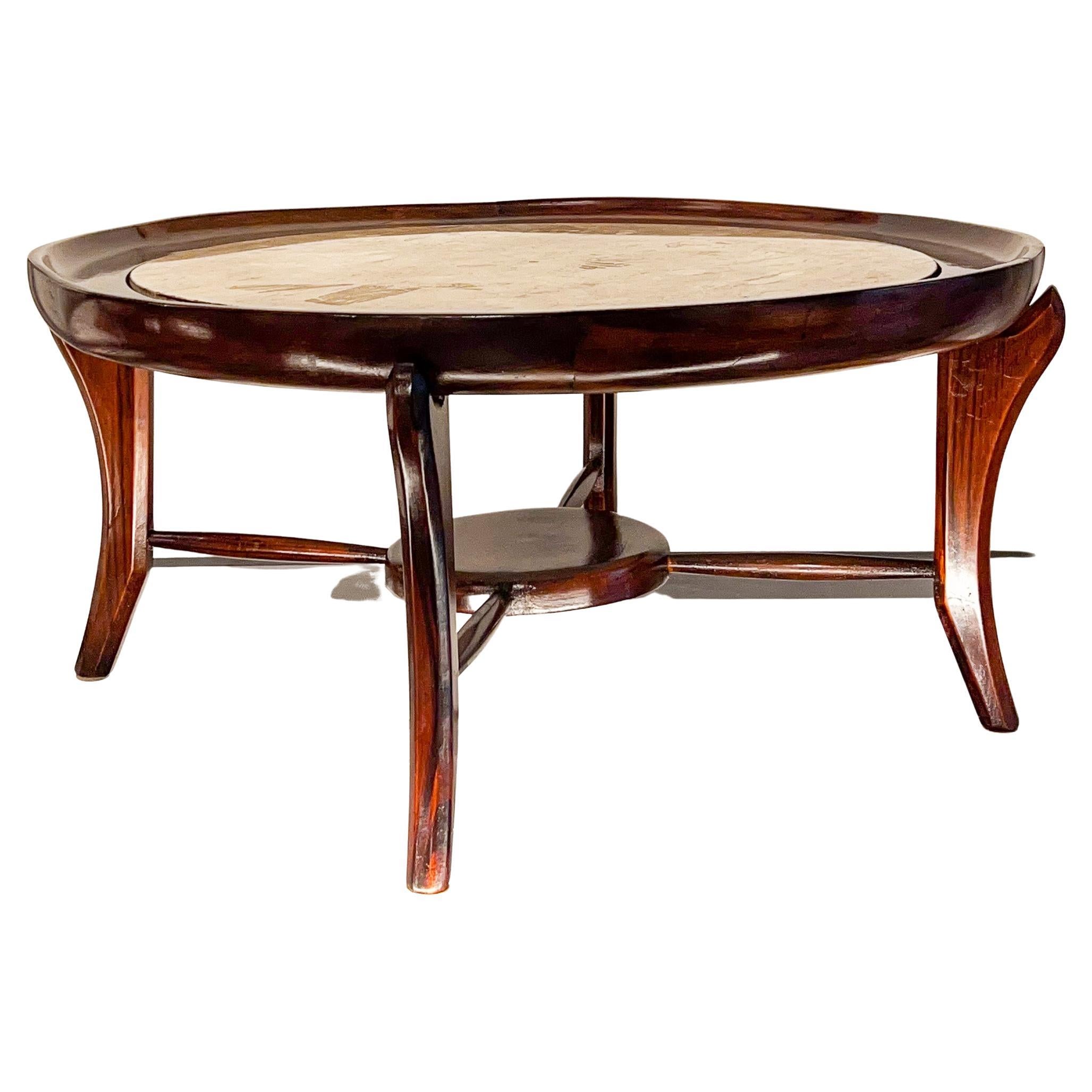 Available today, Giuseppe Scapinelli’s iconic Maracanã coffee table is made of Brazilian Rosewood, as known as Jacaranda and travertine. The top has a circular wood base that holds the travertine, giving a futuristic look when seen from above. The