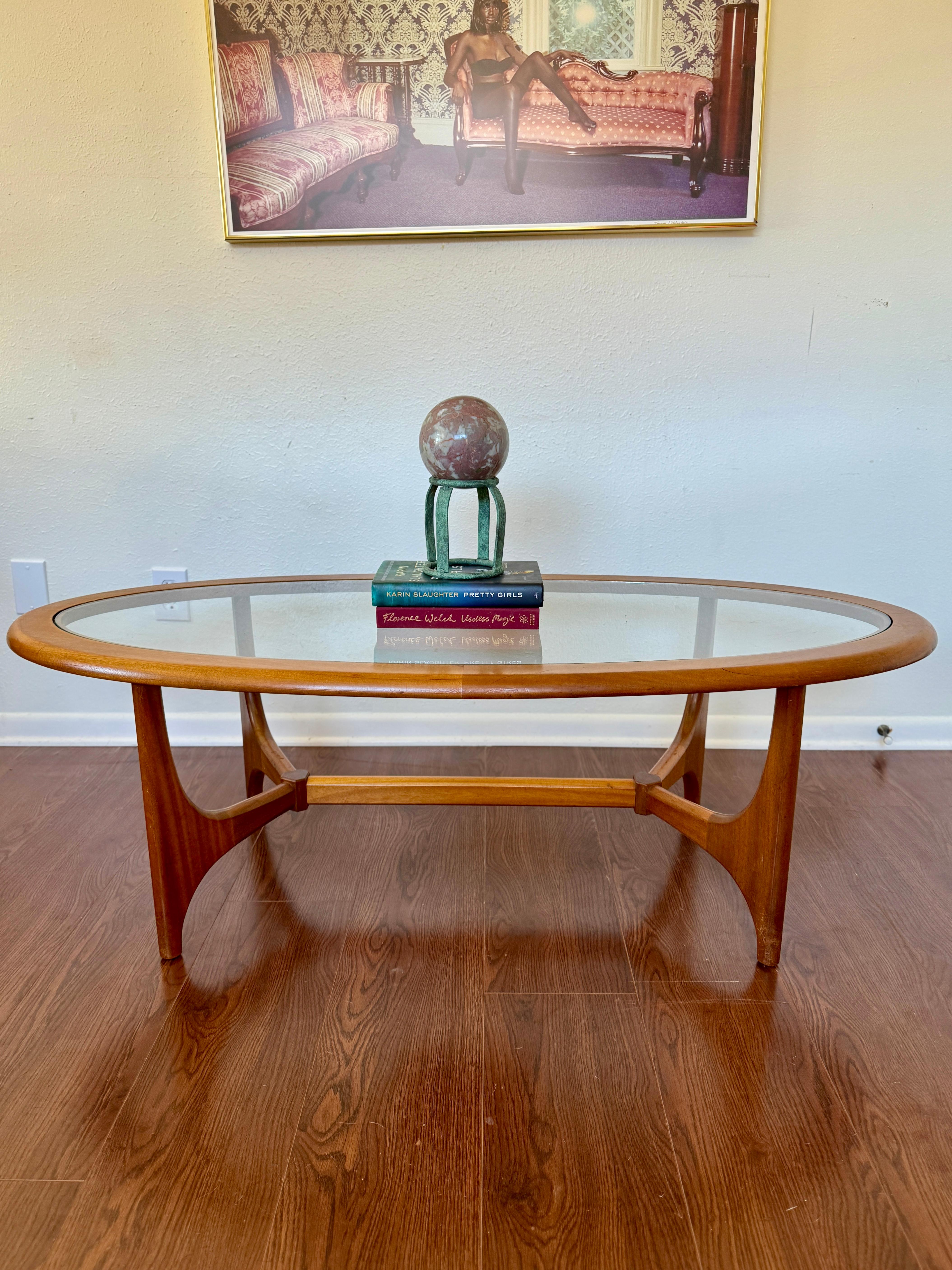 Mid century modern coffee table with a glass top by Stonehill, circa 1960s. Frame is made of teak, and table is in beautiful original condition. 

52” W × 24” D × 17” H
