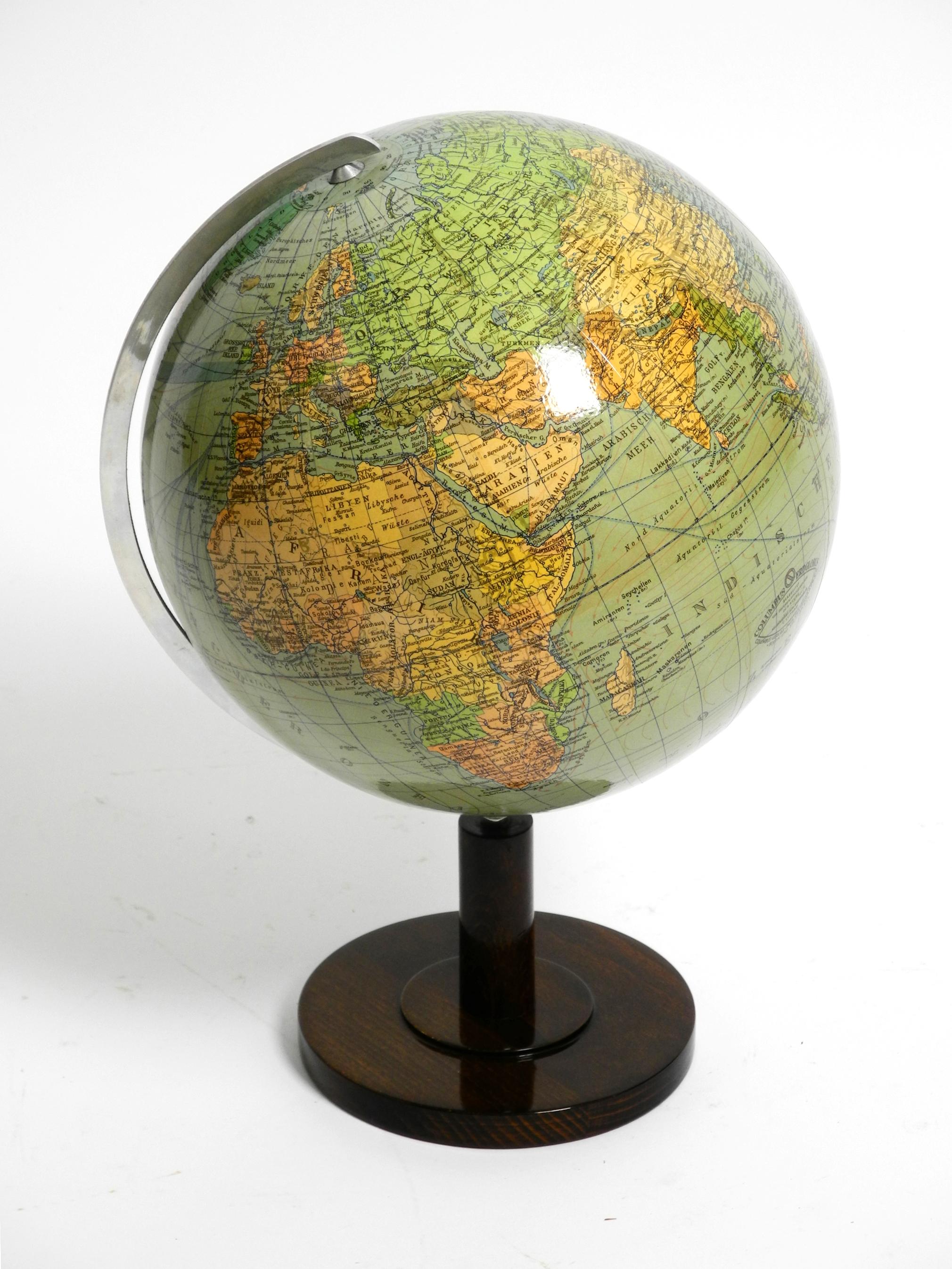 Beautiful 1950s Columbus terrestrial globe. Scale 1:48,000,000.
Produced by Columbus Verlag Paul Oestergaard K.G. Berlin and Stuttgart.
Base made of shiny walnut wood. The globe is made of bakelite. The axle is metal.
The globe is in very good